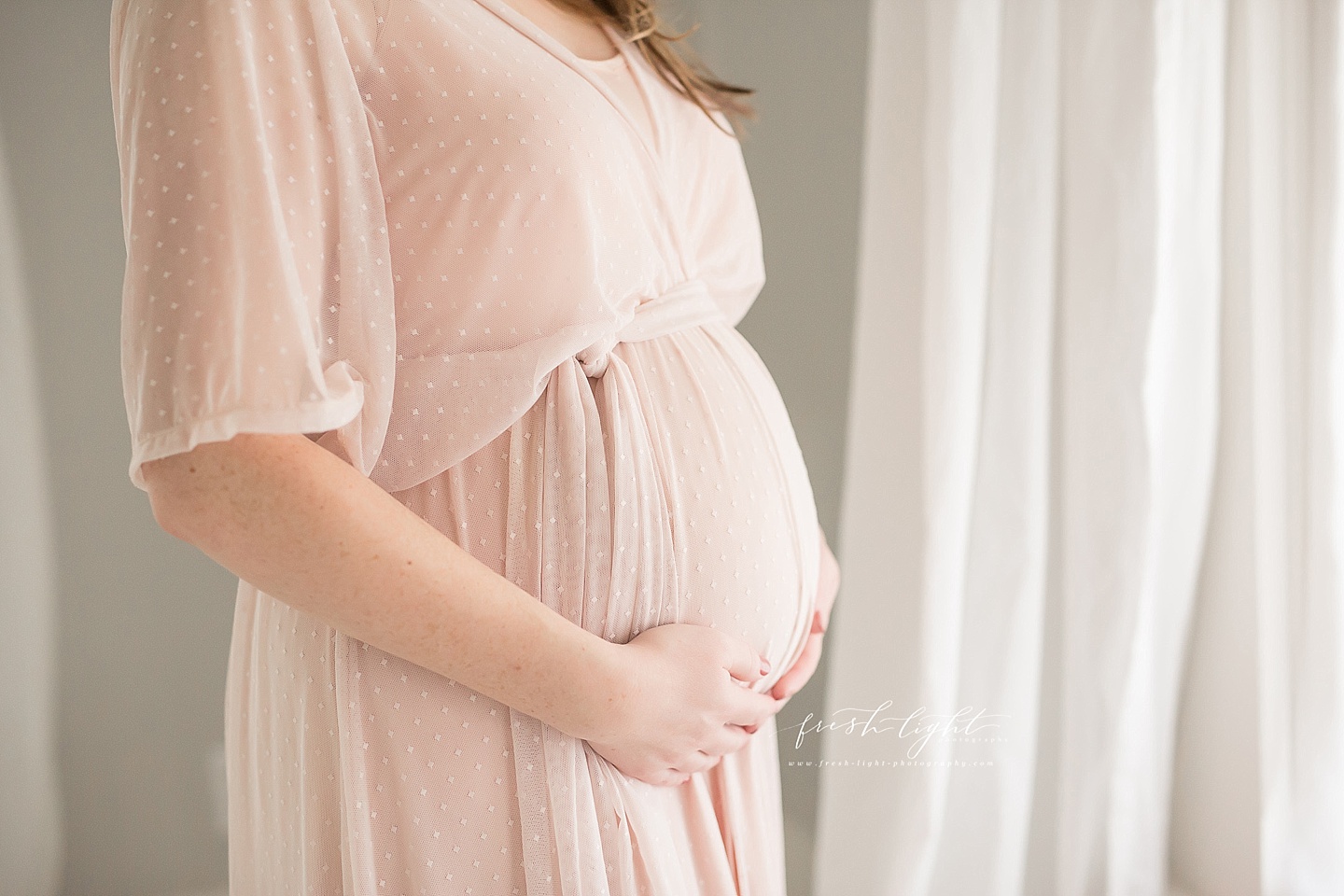 pregnant belly in a pink dress