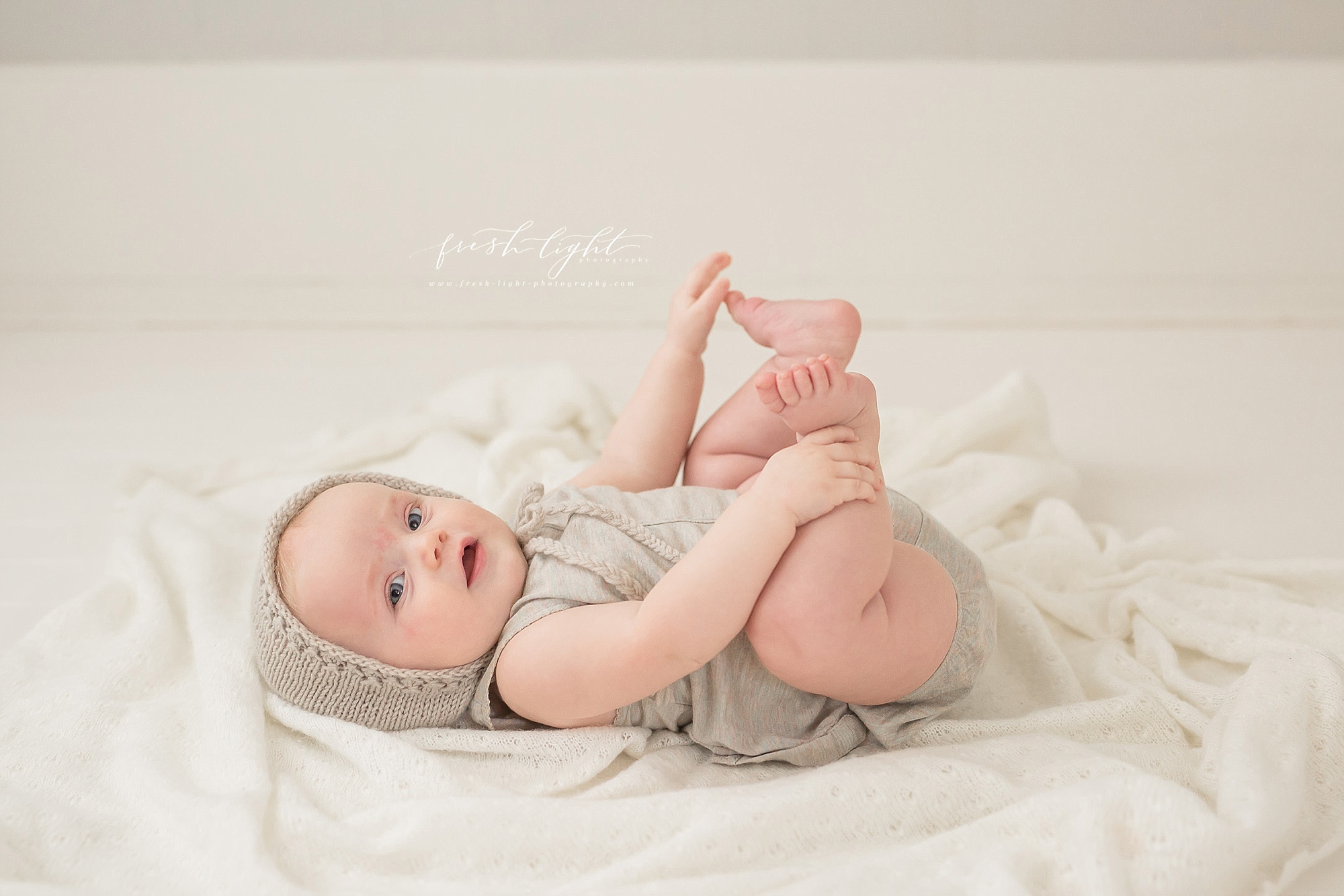 4 month old baby grabbing her toes