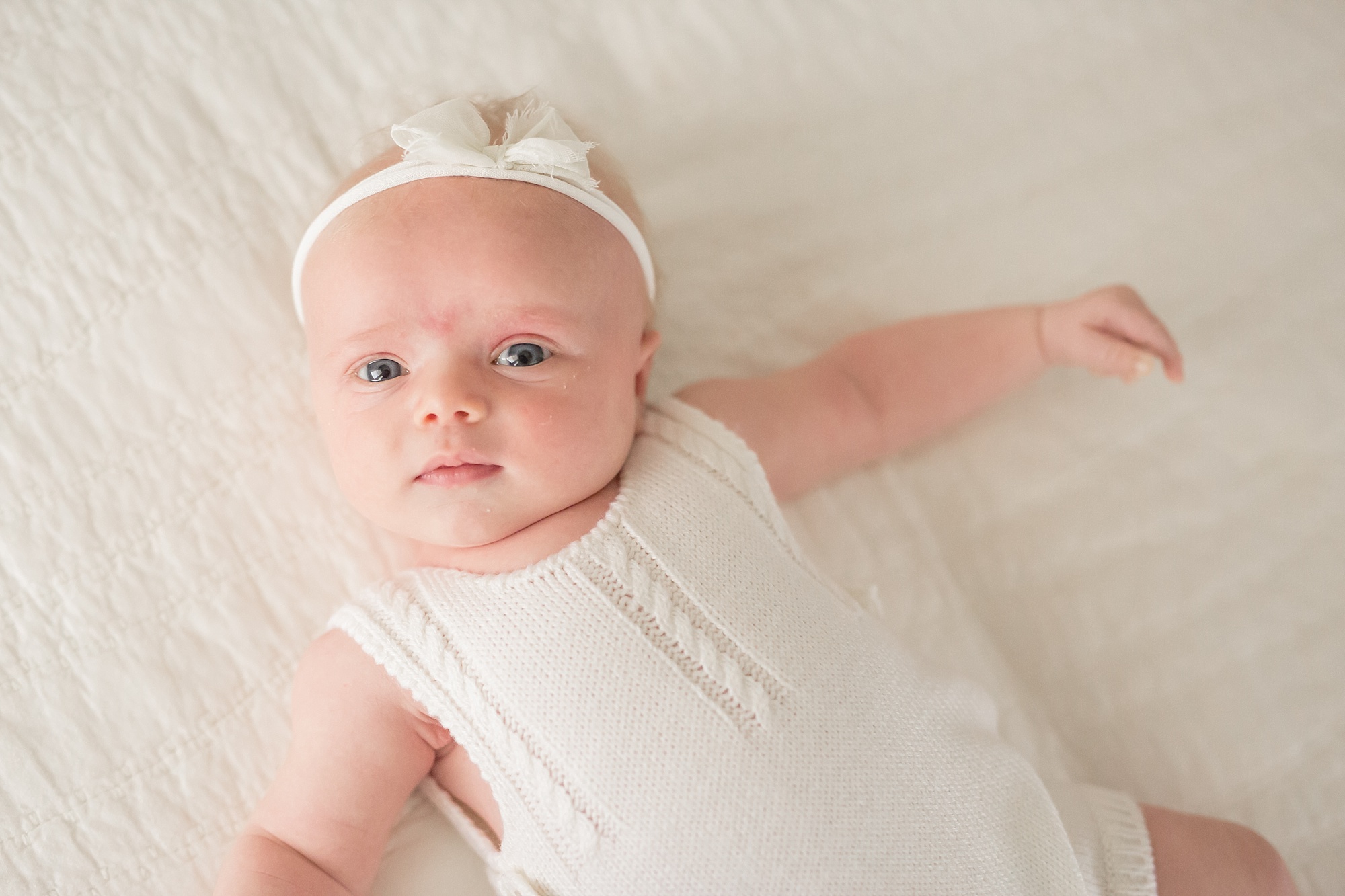 1 month old baby girl in white knit romper