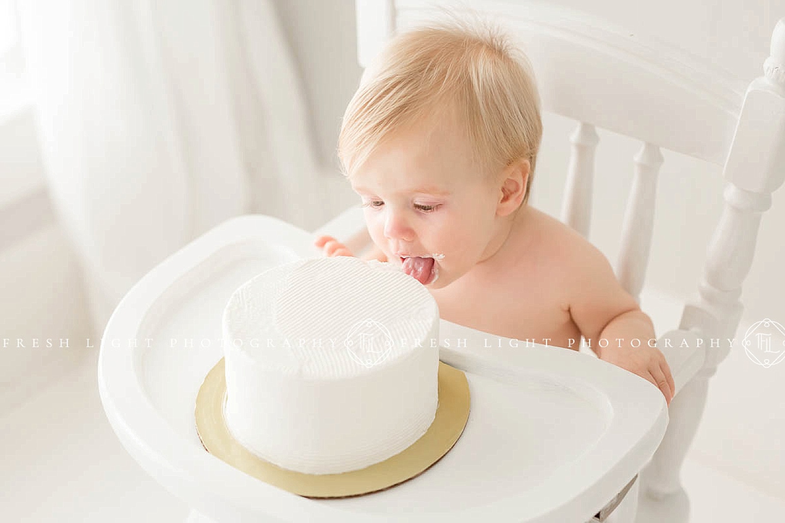baby licking her cake a her 1 year photography session