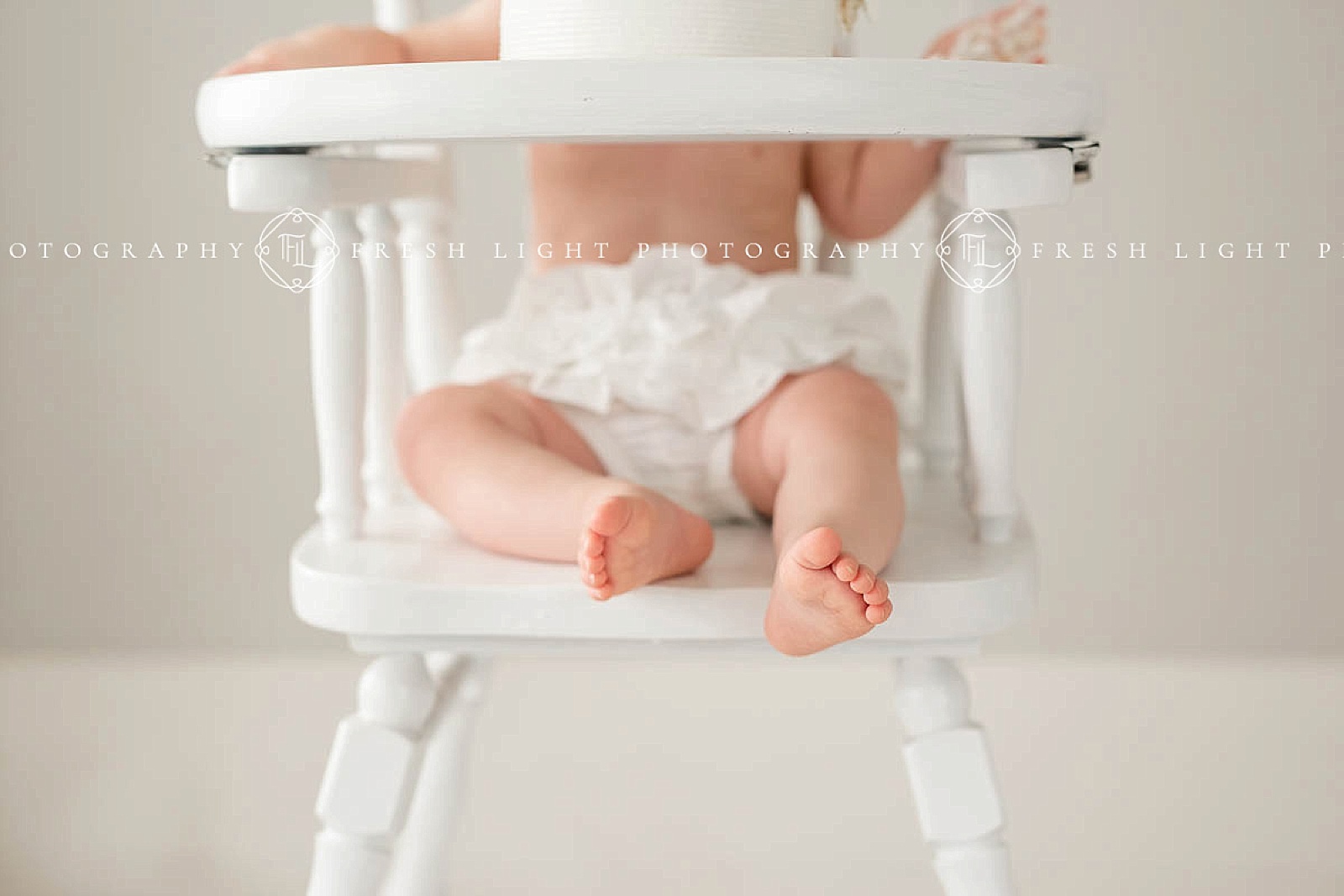 close up of baby toes while sitting in a high chair