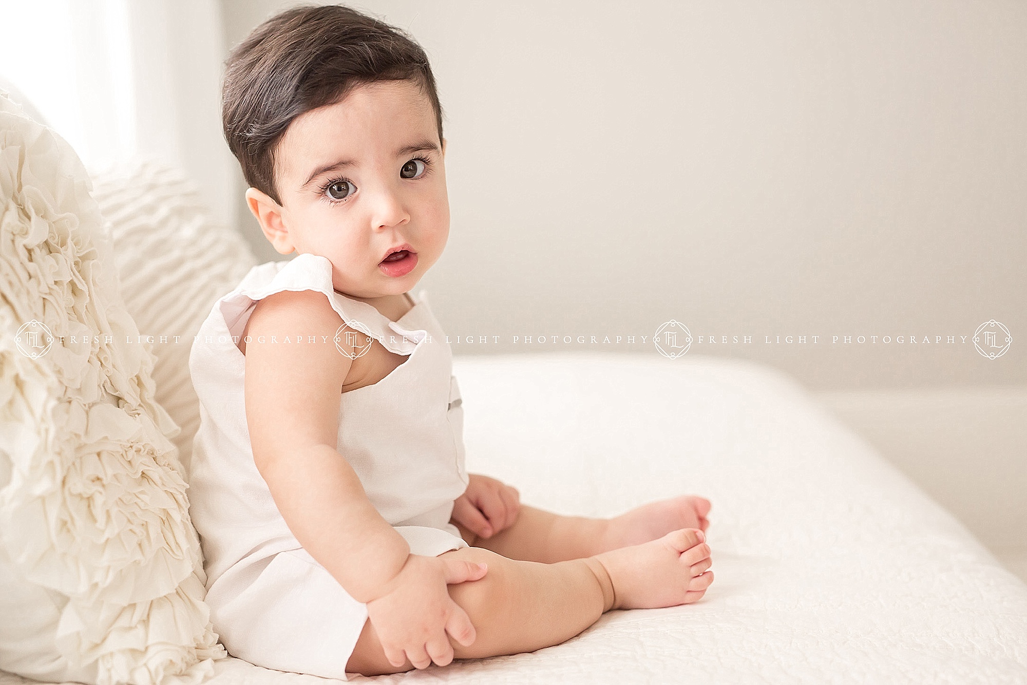 baby boy wearing white at photography session houston