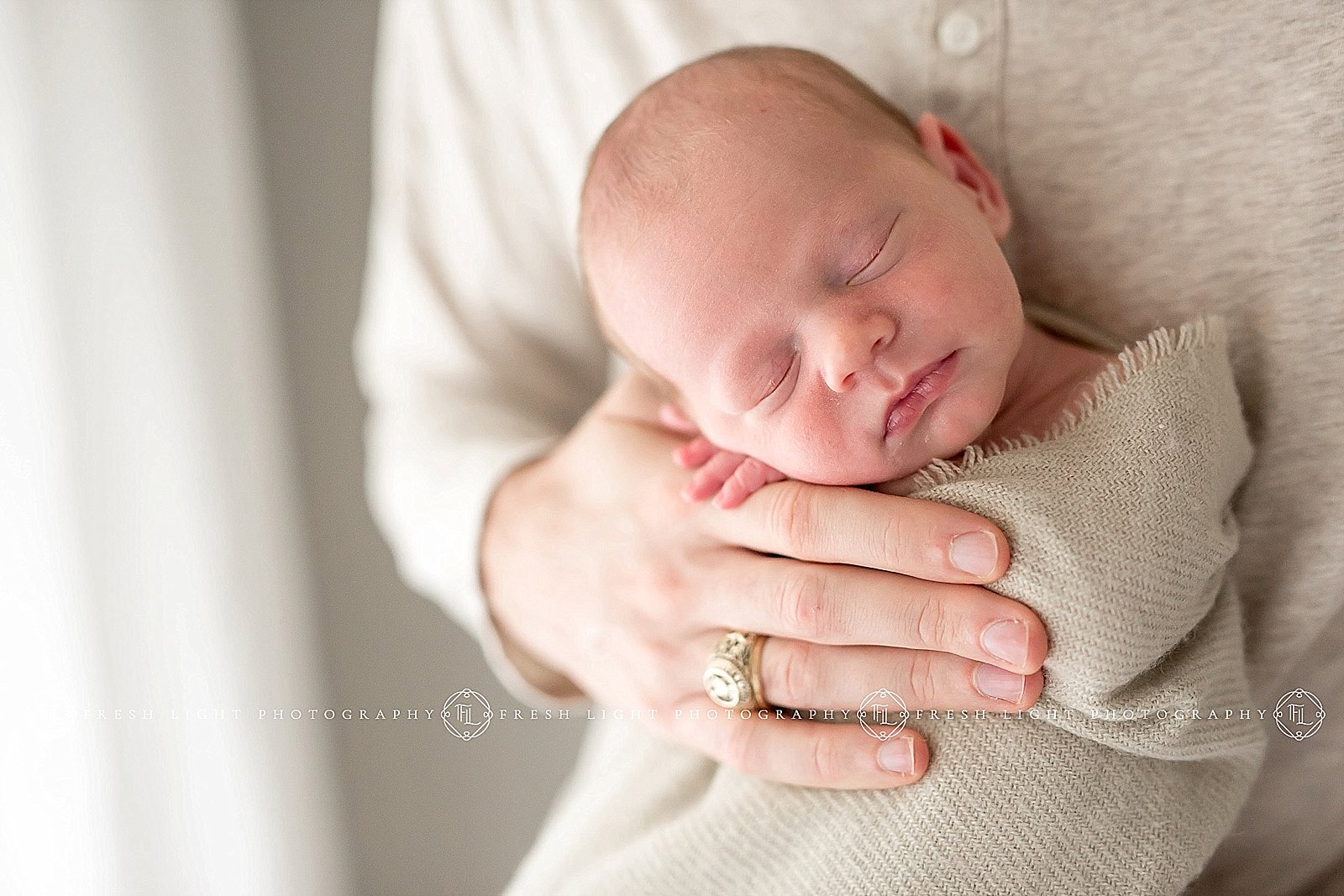 dad wearing his Aggie ring at a newborn session in Houston