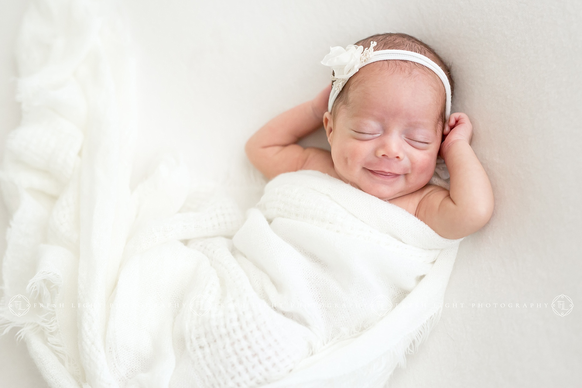 Newborn girl smiling in studio picture