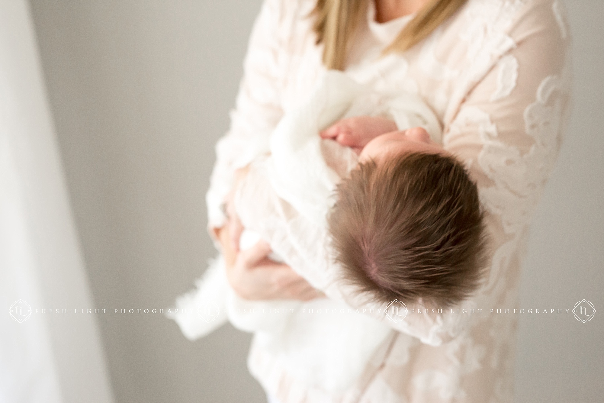 Mom holding newborn in Houston Photography