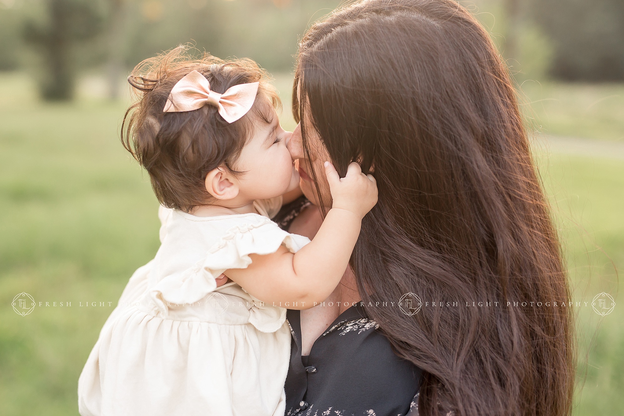 Baby girl kissing mom