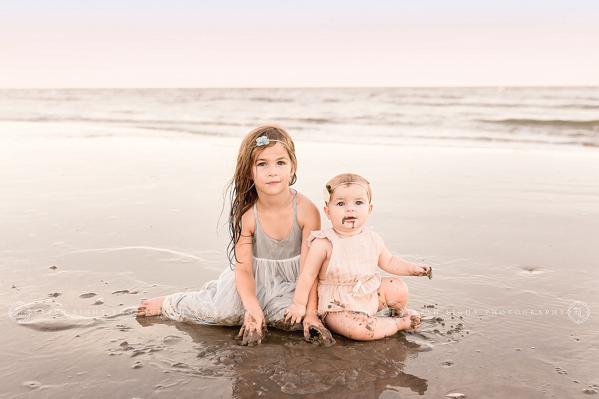Siblings sitting on the beach