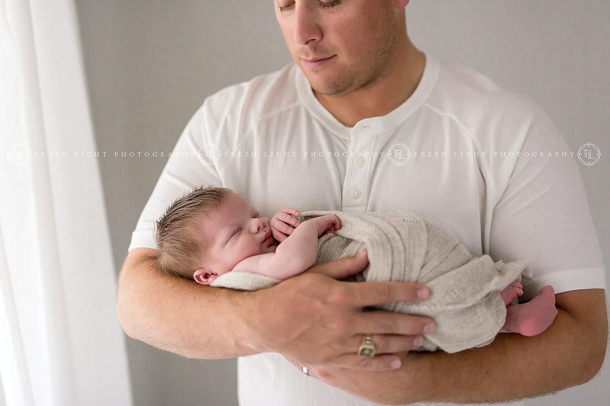 Father holding newborn baby