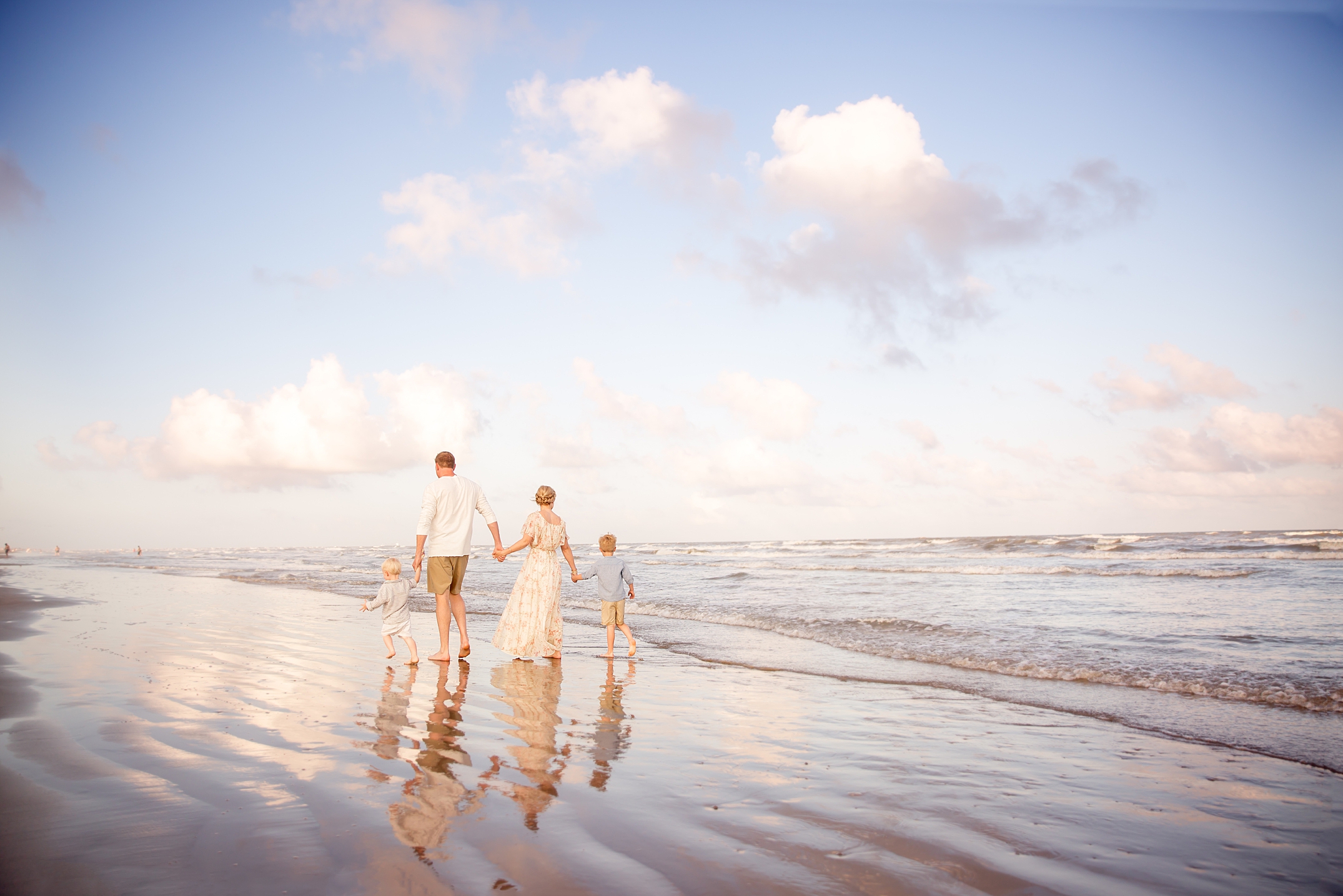 family walking together on the beach