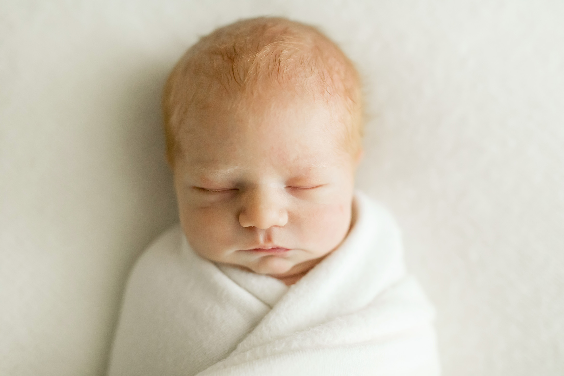 portrait of newborn baby on a white blanket in the heights
