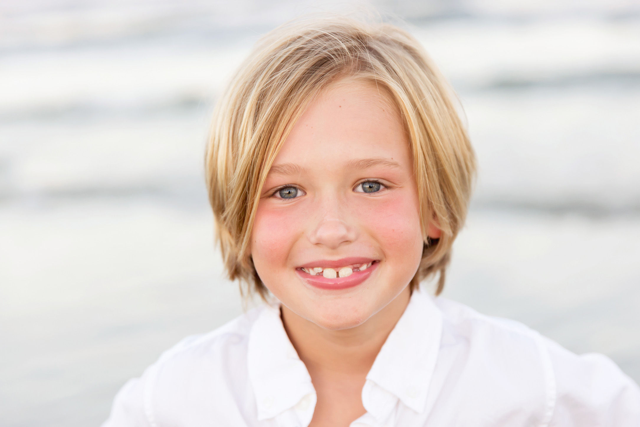 boy smiling at the camera on beach