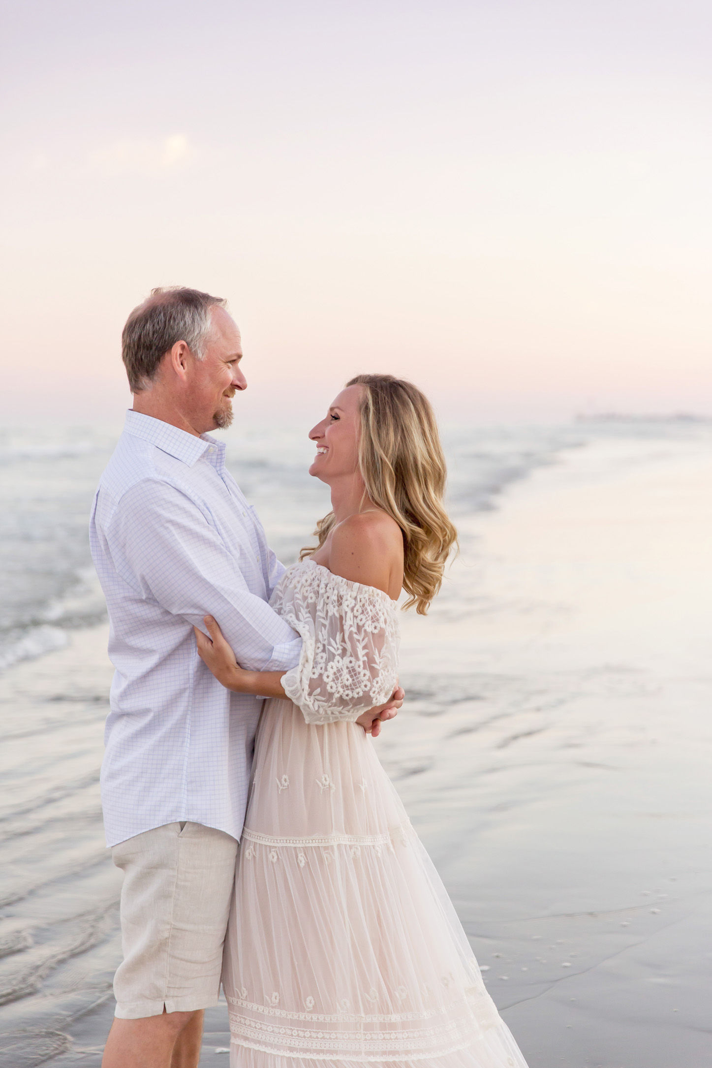 couple embracing during family pictures on Galveston