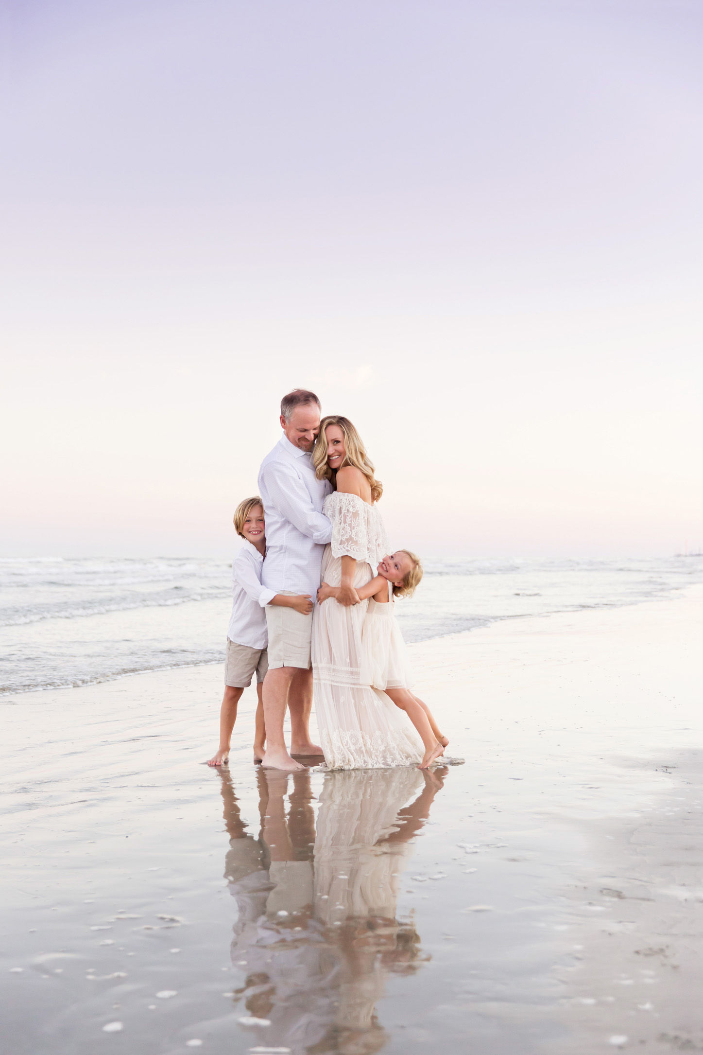 family hugging each other at sunset family pictures on Galveston