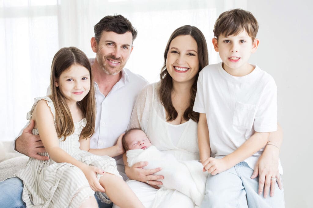 Family sharing a loving moment together during a professional family photography session in Houston, Texas