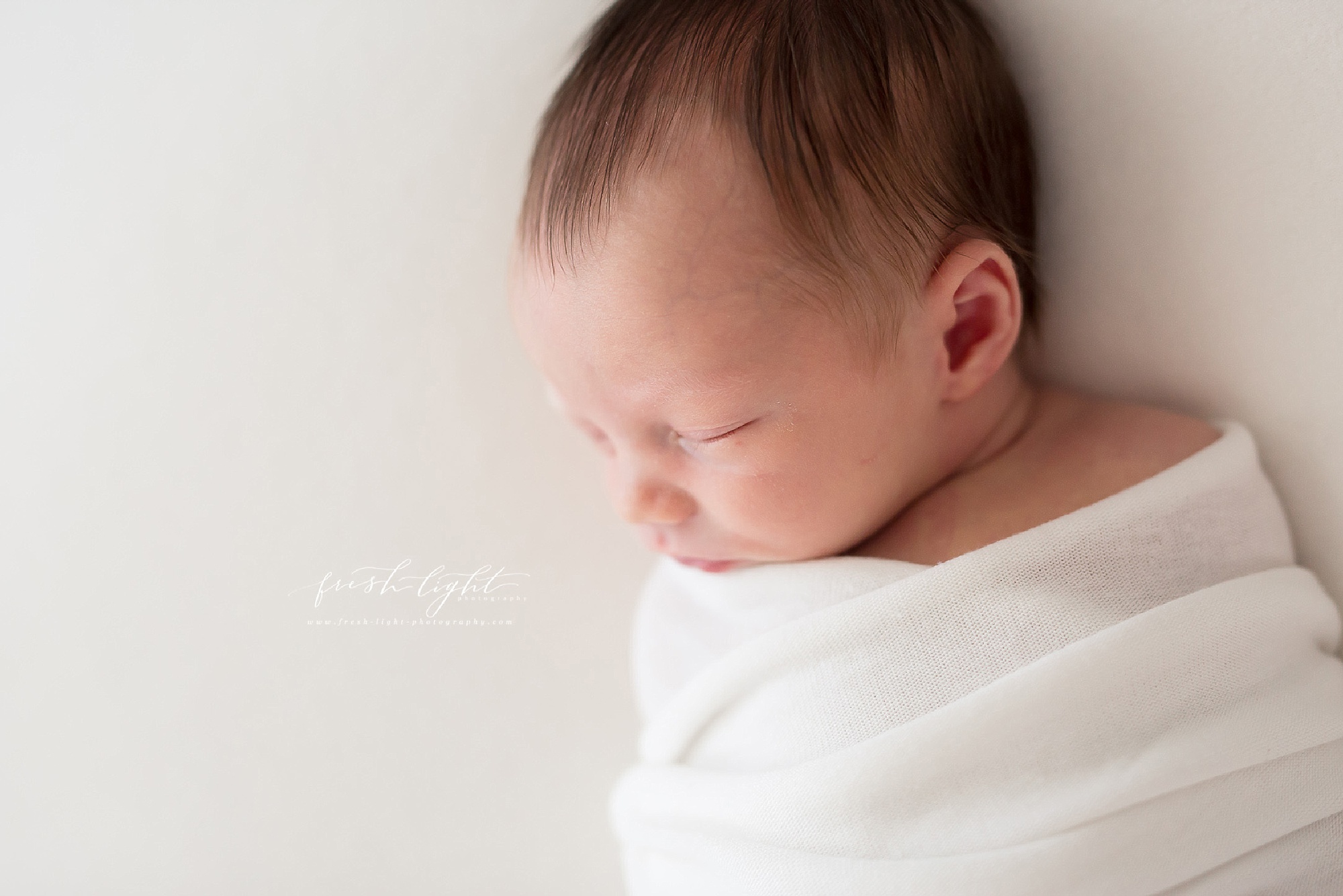 Newborn boy on white blanket in houston