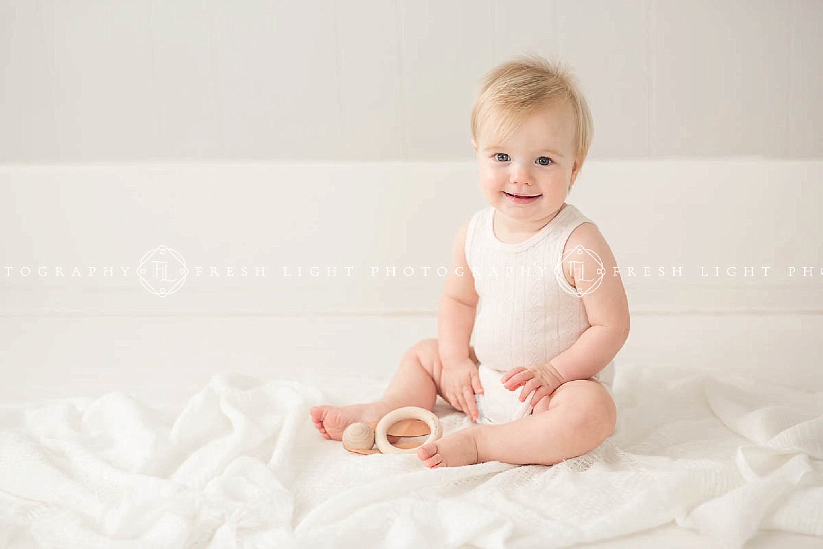 baby in all white photography studio