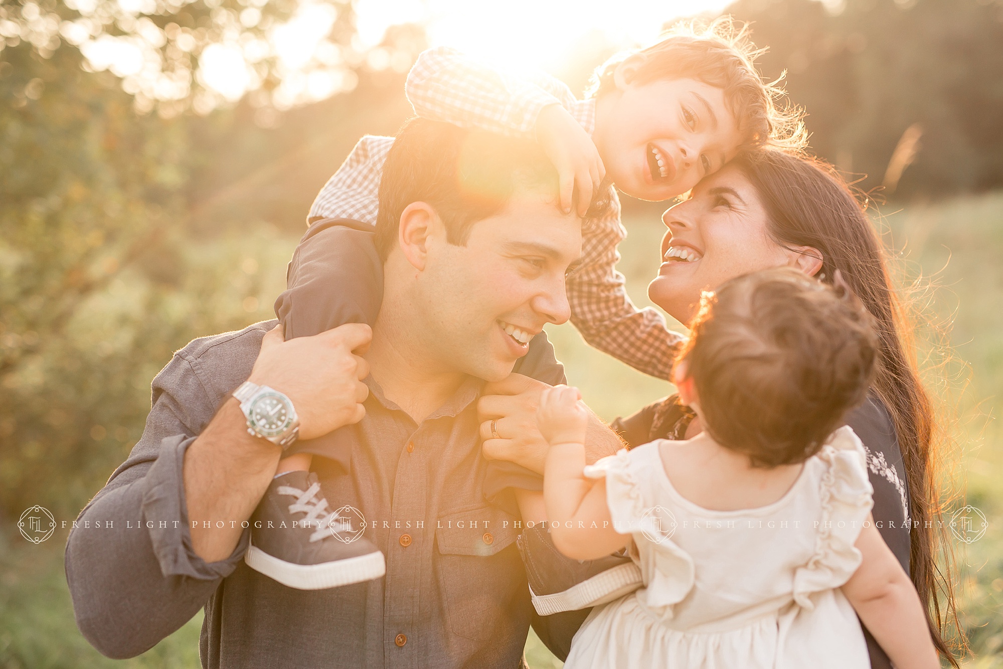 Mom and Dad holding children during houston family photography session