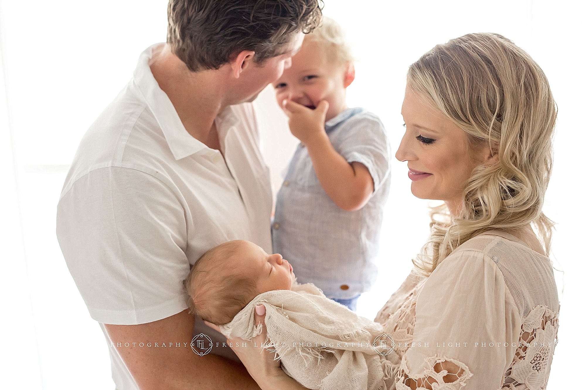 Family together, mom holding newborn