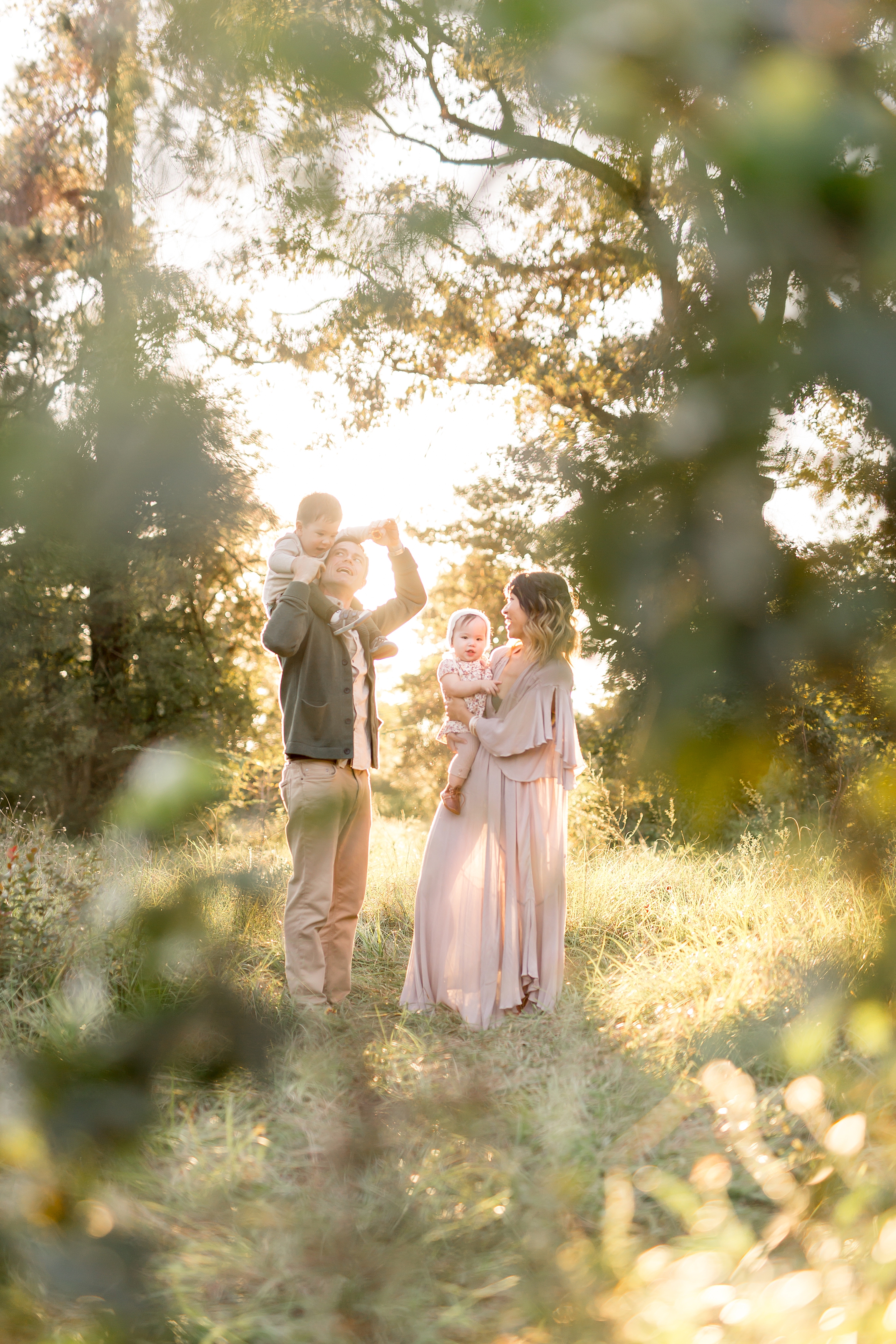 family playing in a field 