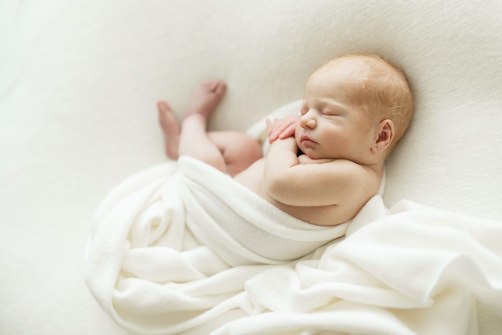newborn wrapped in womb pose