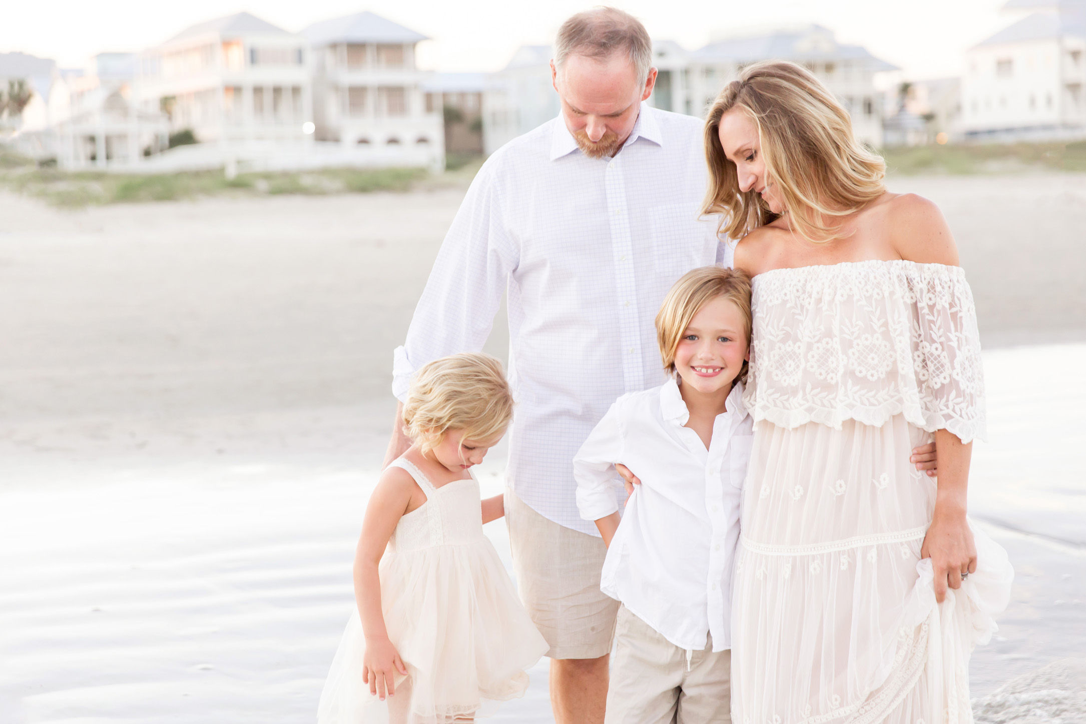 family cuddling together during houston beach photography session