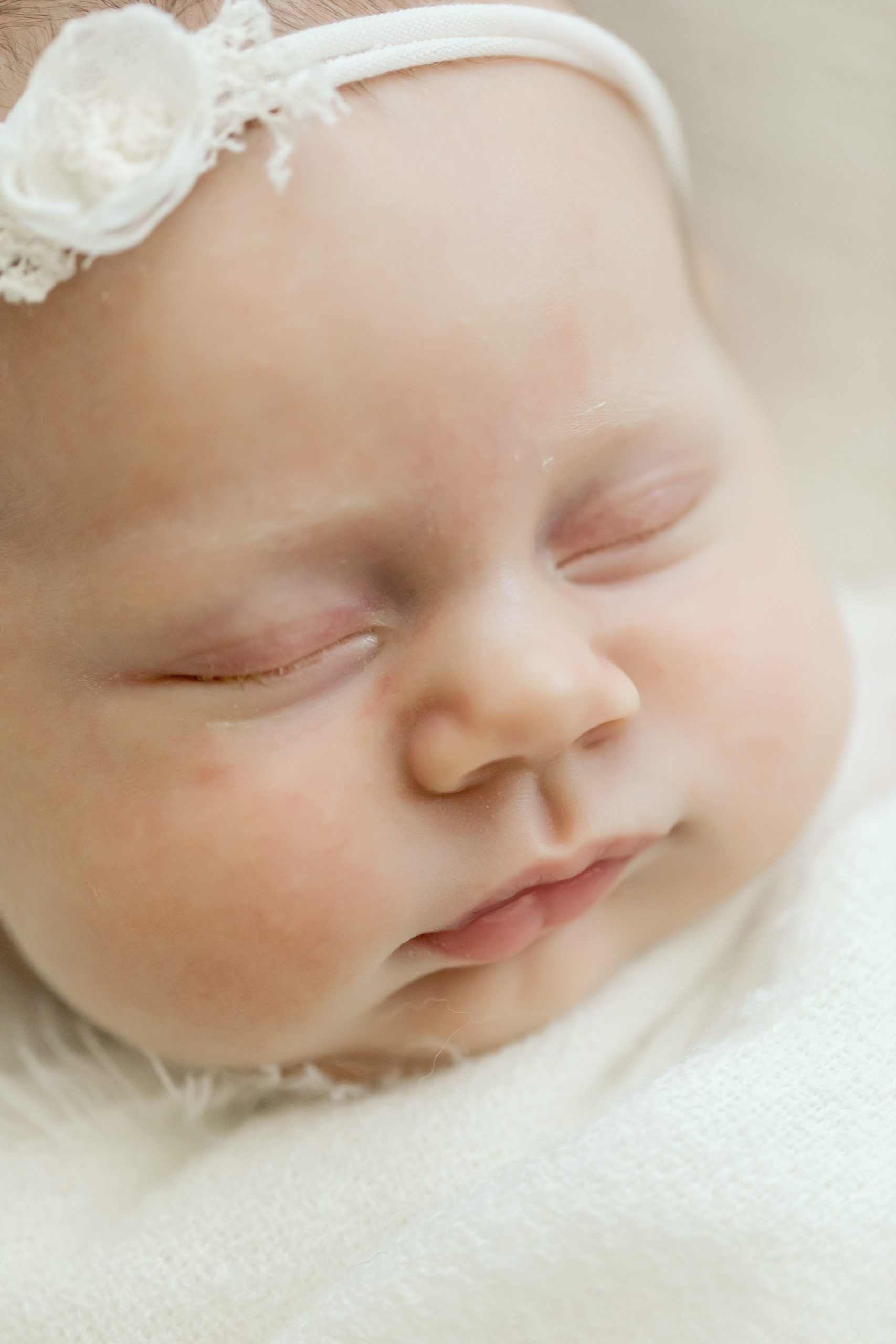 close up of newborn with big cheeks
