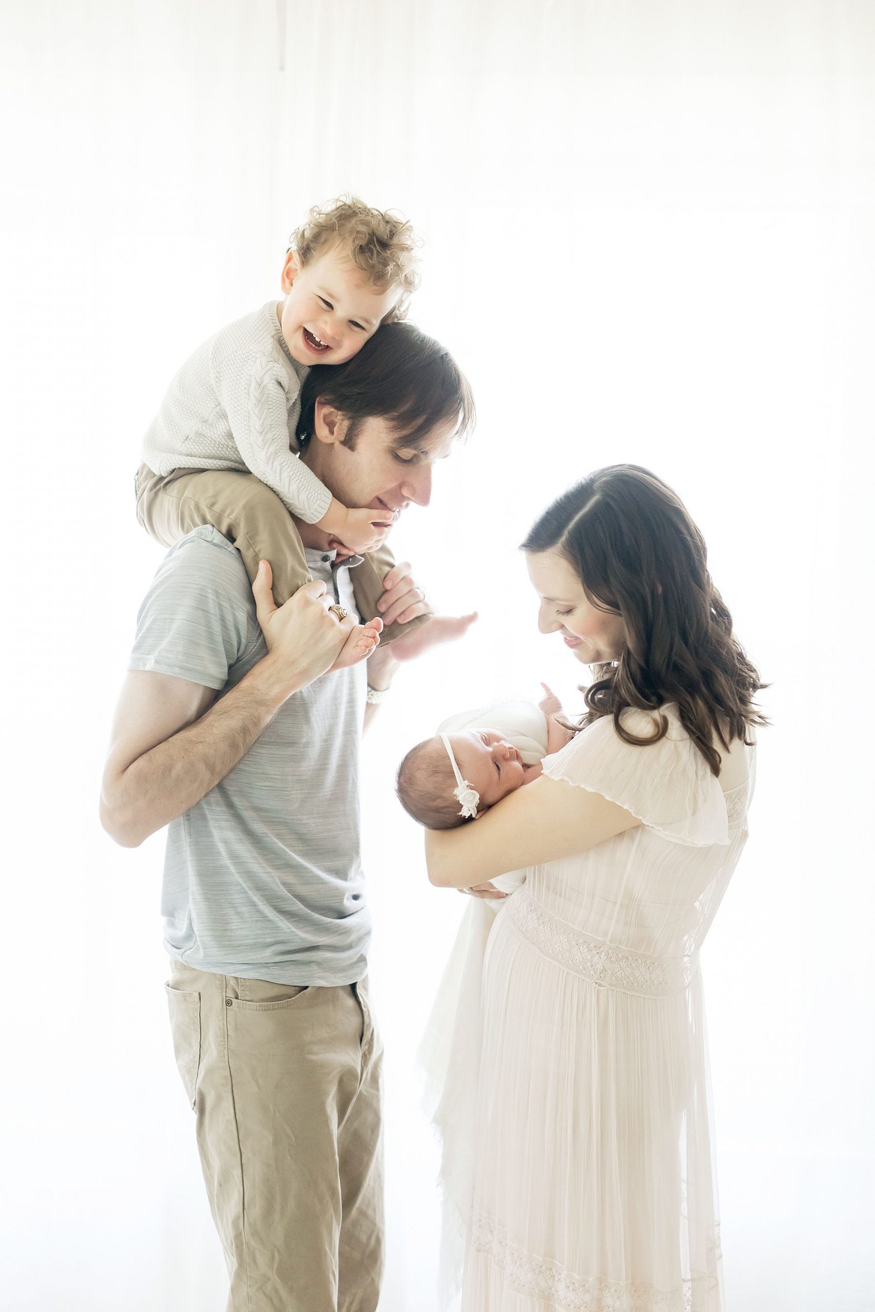 toddler sitting on dads shoulders during photography session