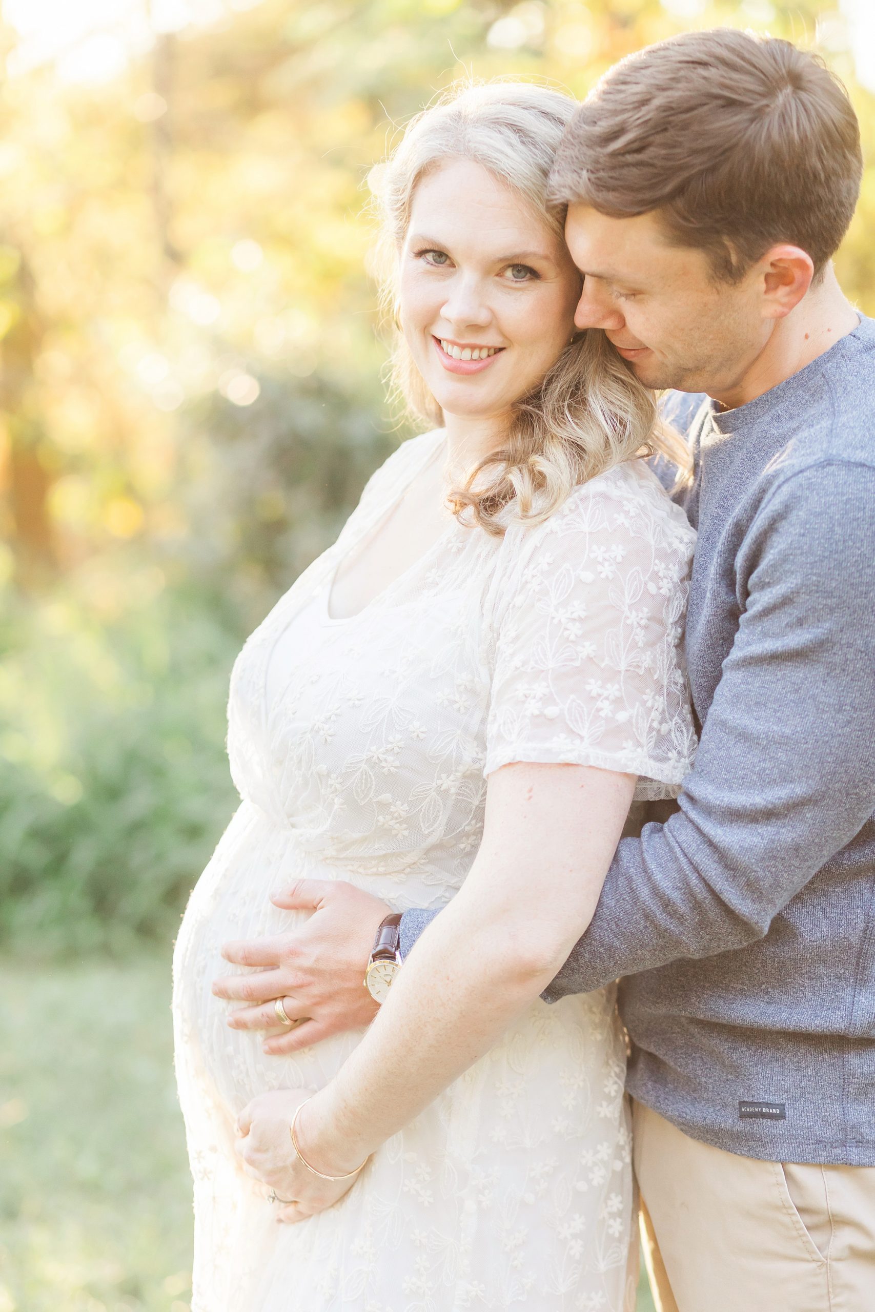 dad whispering to mom during maternity session