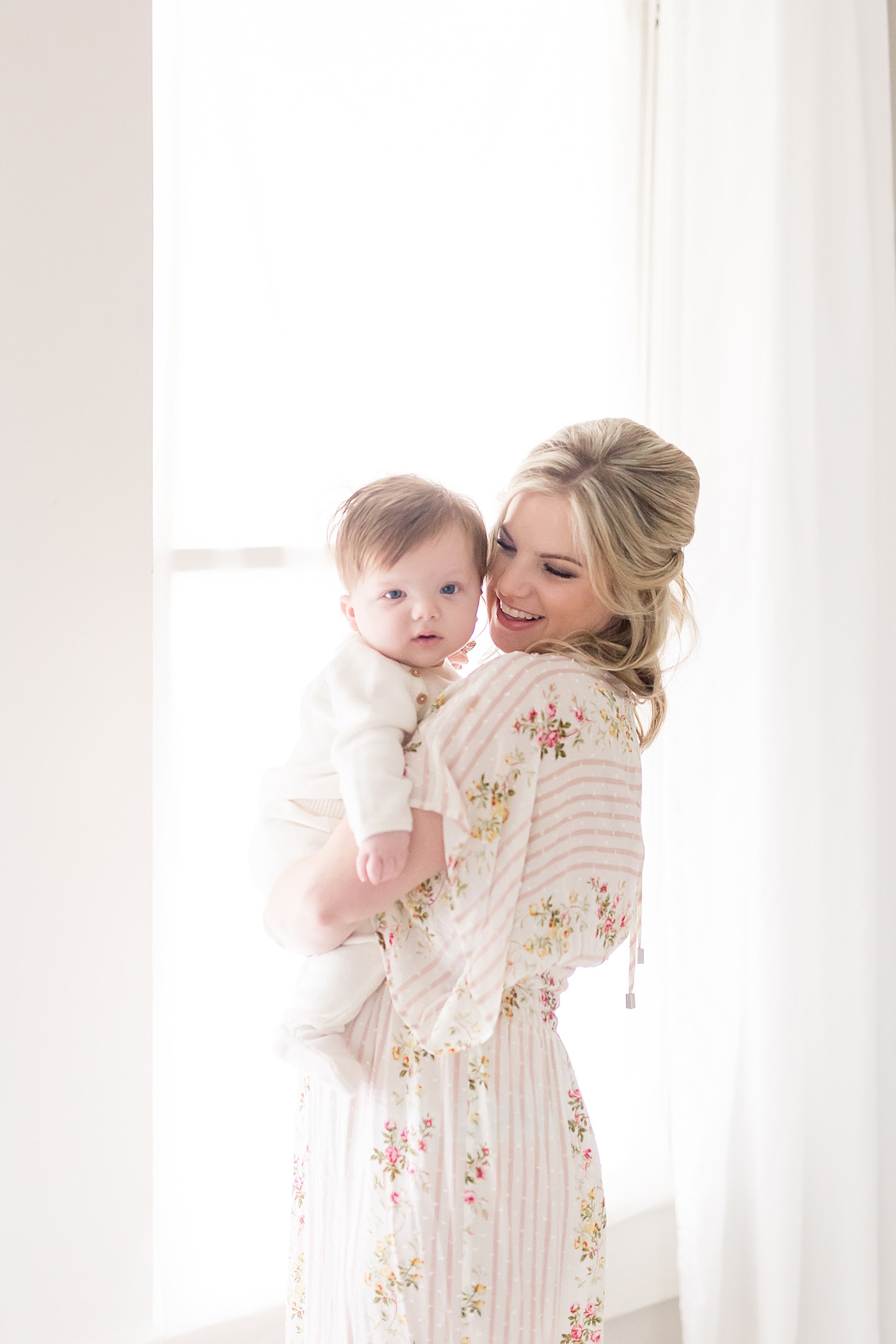 Mom and baby in front of a big window with beautiful light. Photos by Fresh Light Photography.