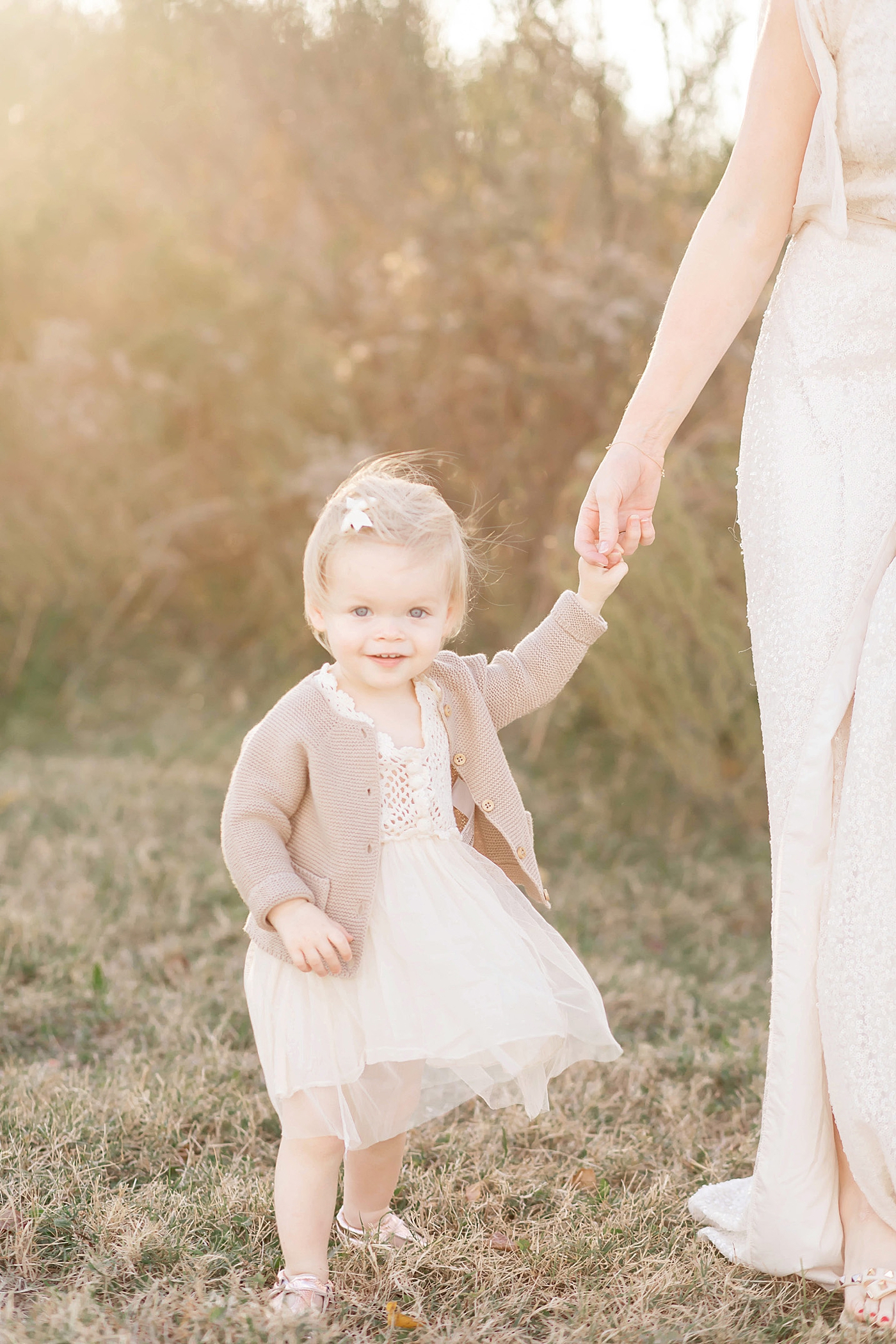 Golden sunset photo of little girl in a beautiful dress for her first birthday. Photos by Fresh Light Photography in The Heights near Houston, Texas.