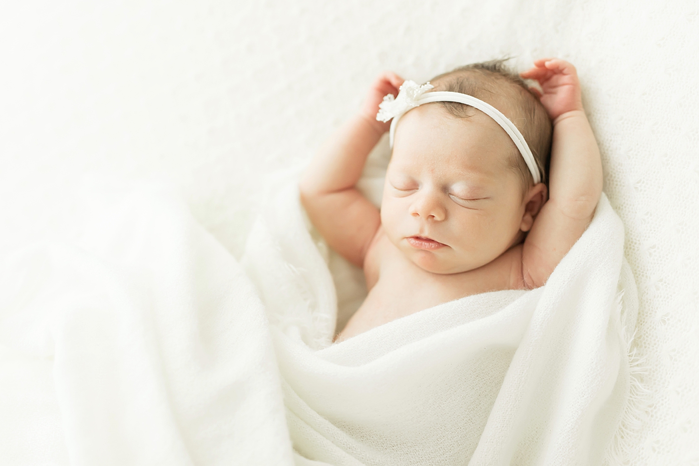 Baby girl with her arms up sleeping. Photos by Fresh Light Photography.