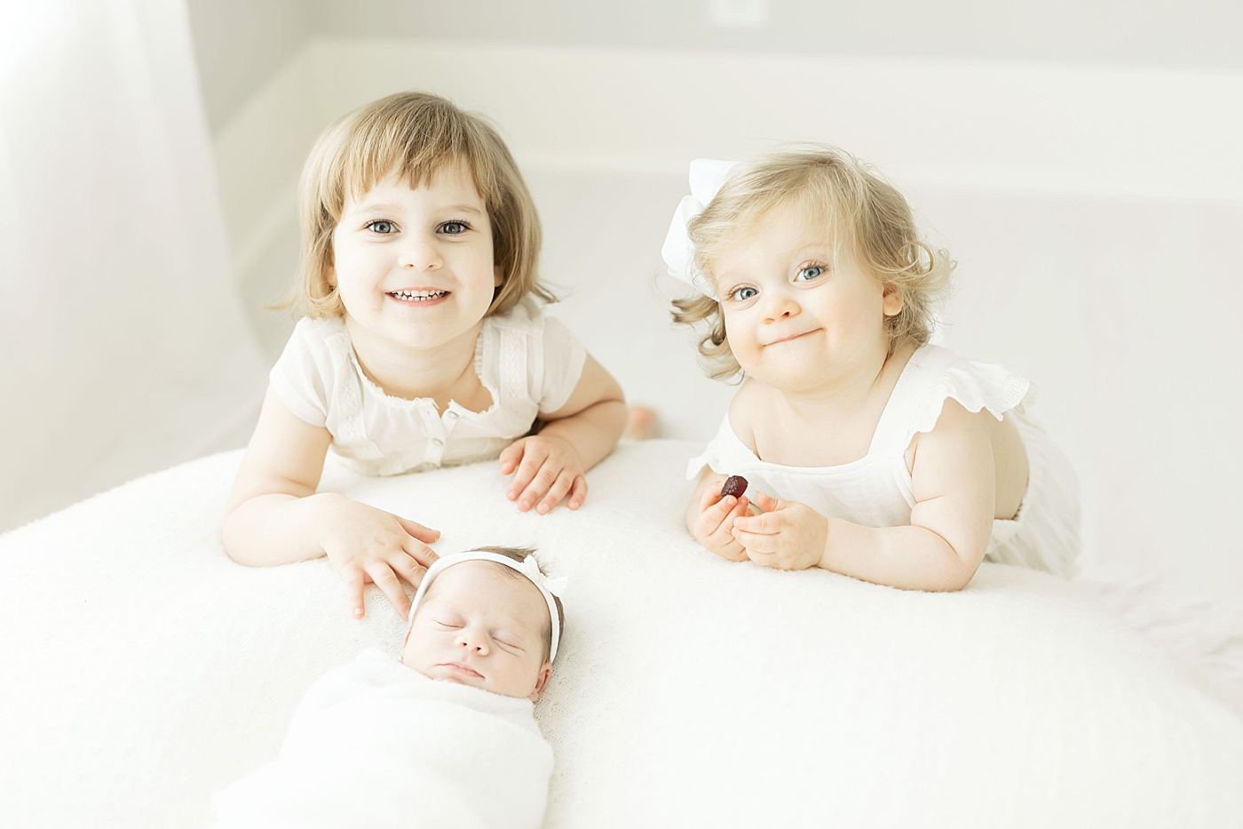 Three sisters in the newborn studio in The Heights. Photos by Fresh Light Photography.