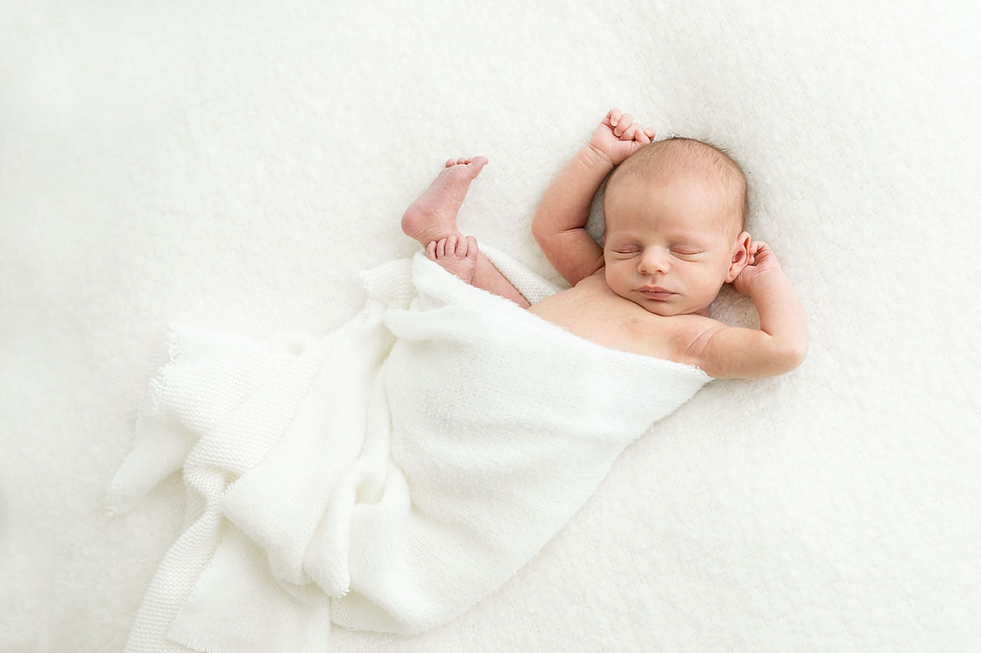Baby sleeping with arms up by his head. Photos by Fresh Light Photography.