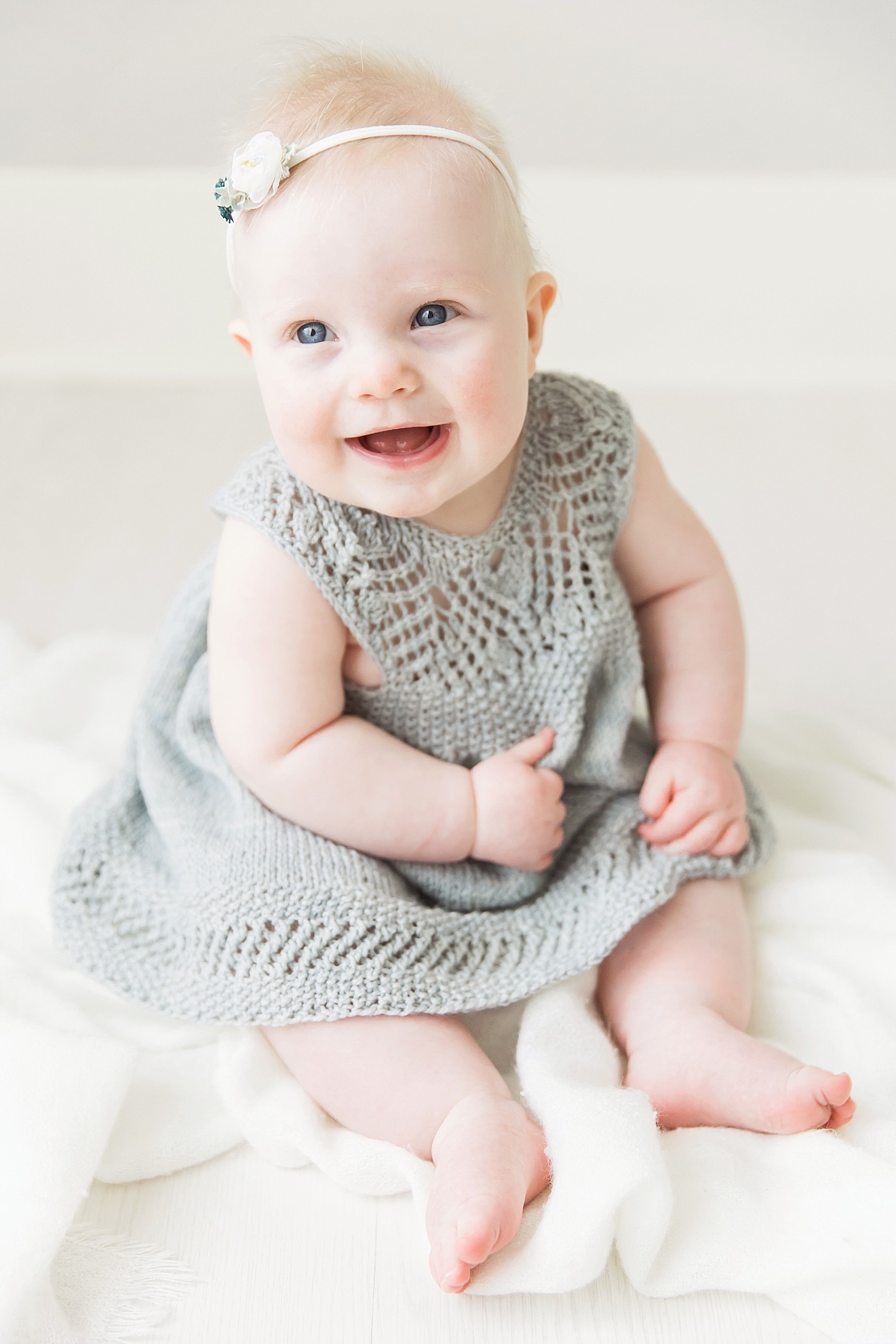 Six month old baby girl laughing and smiling. Photos by Fresh Light Photography.