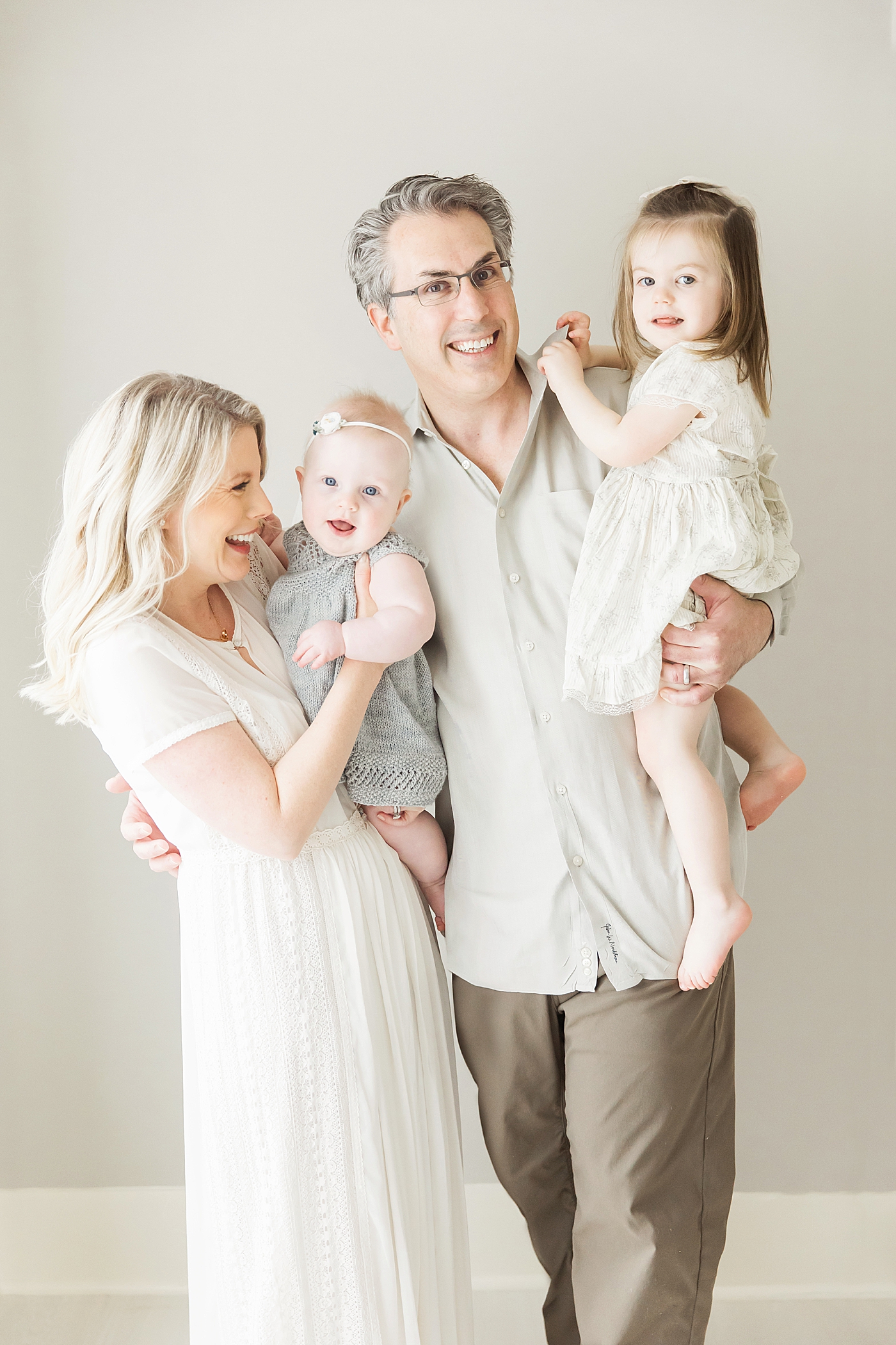 Family portrait of Mom, Dad and two daughters in Houston Heights Studio. Photos by Fresh Light Photography.