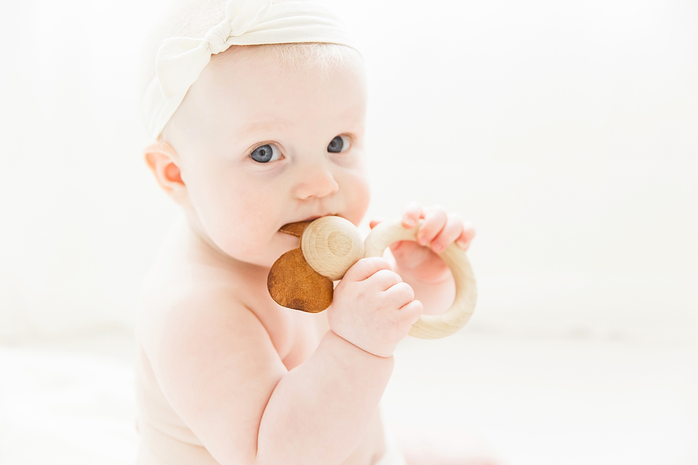 Six month old chewing on wood toy. Photos by Fresh Light Photography.