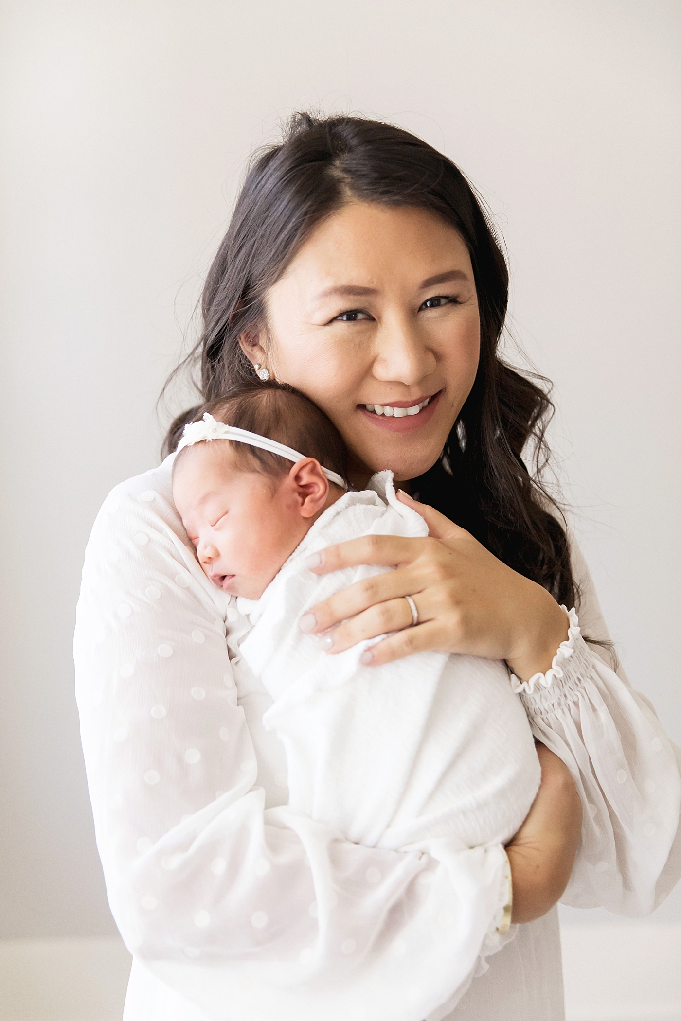 Mom holding newborn baby girl on her shoulder as she sleeps. Photos by Fresh Light Photography. 