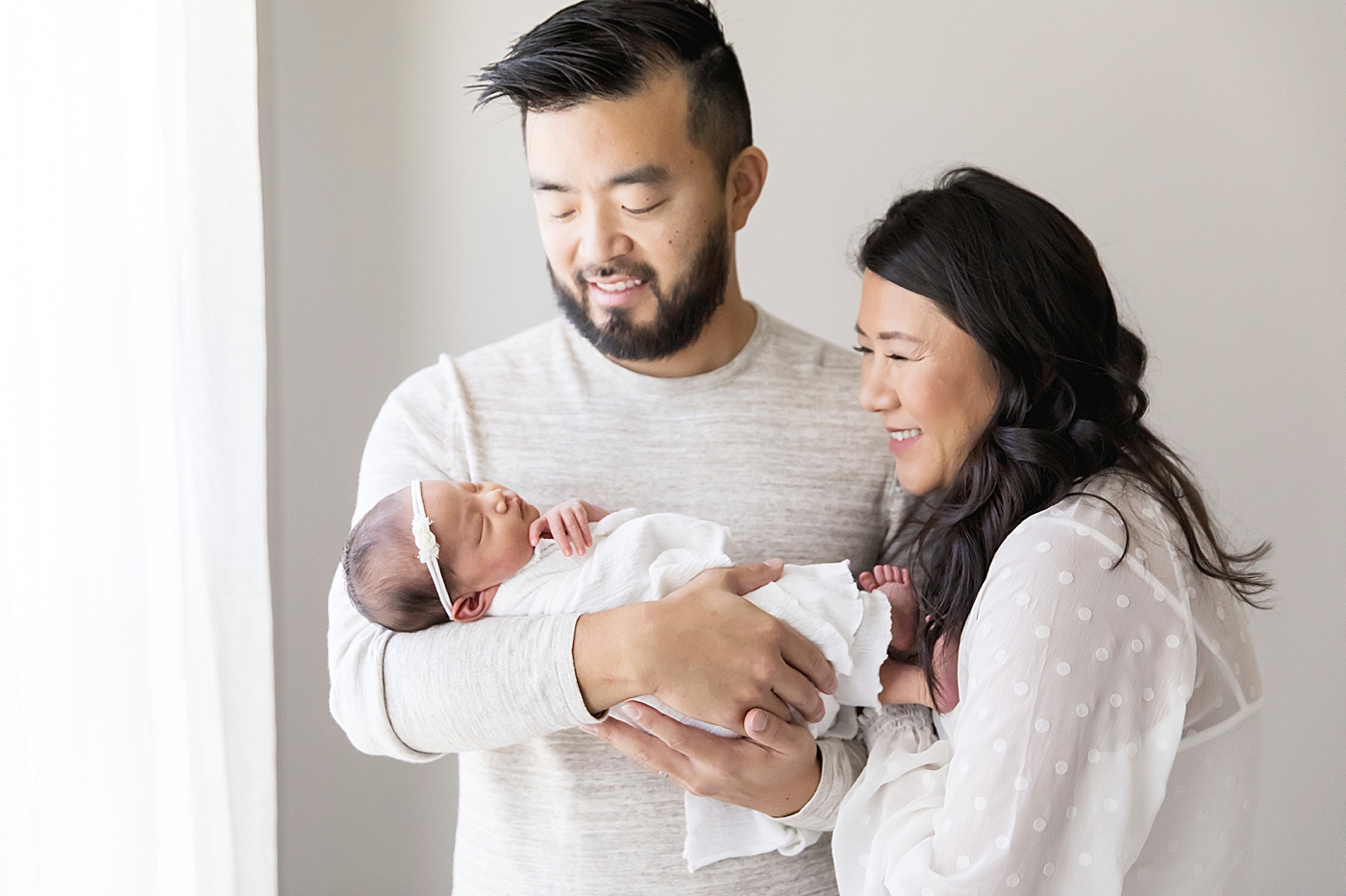 Mom and Dad looking at newborn baby girl | Fresh Light Photography