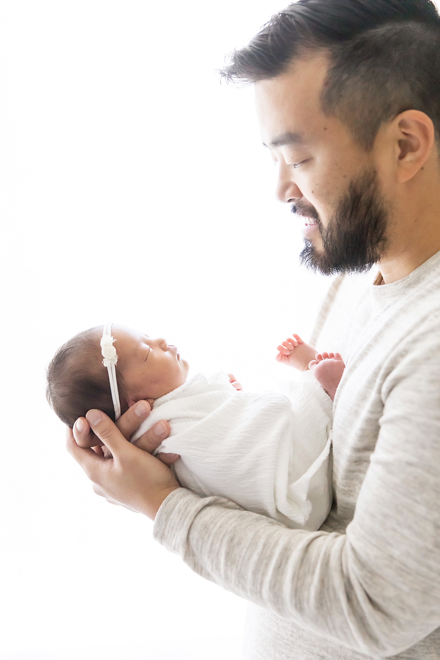 Backlit photo of Dad and daughter during her newborn session | Fresh Light Photography
