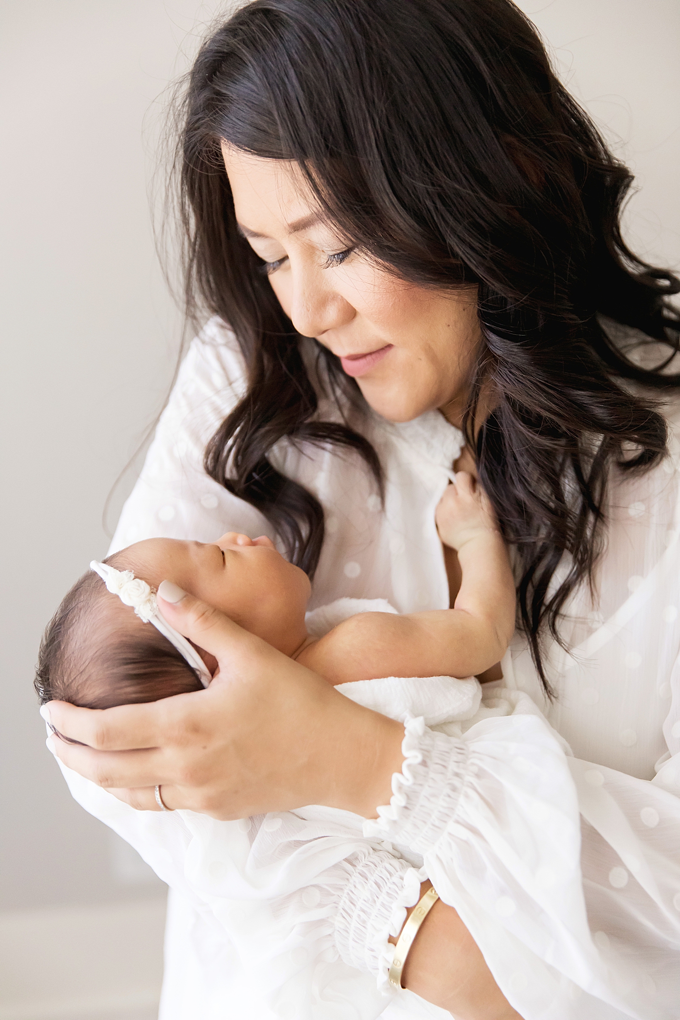 Sweet moment between Mom and her daughter at newborn photoshoot in the Heights with Fresh Light Photography.