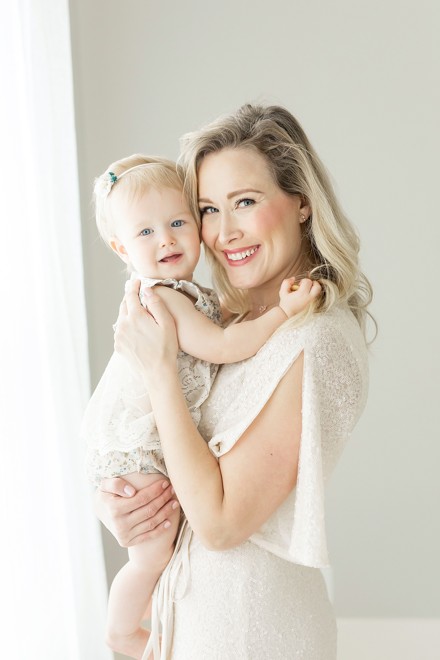 Mom and daughter smiling for photo together with Fresh Light Photography.