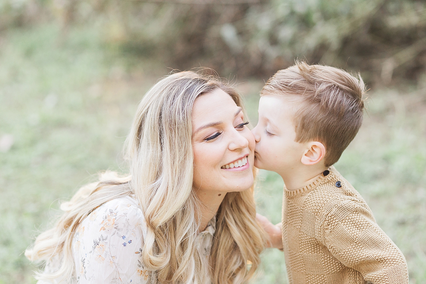 Son giving Mom a kiss during family session with Fresh Light Photography in Houston.