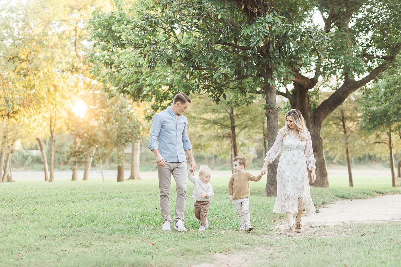Family of four walking through the park in The Heights during their sunset session with Fresh Light Photography.