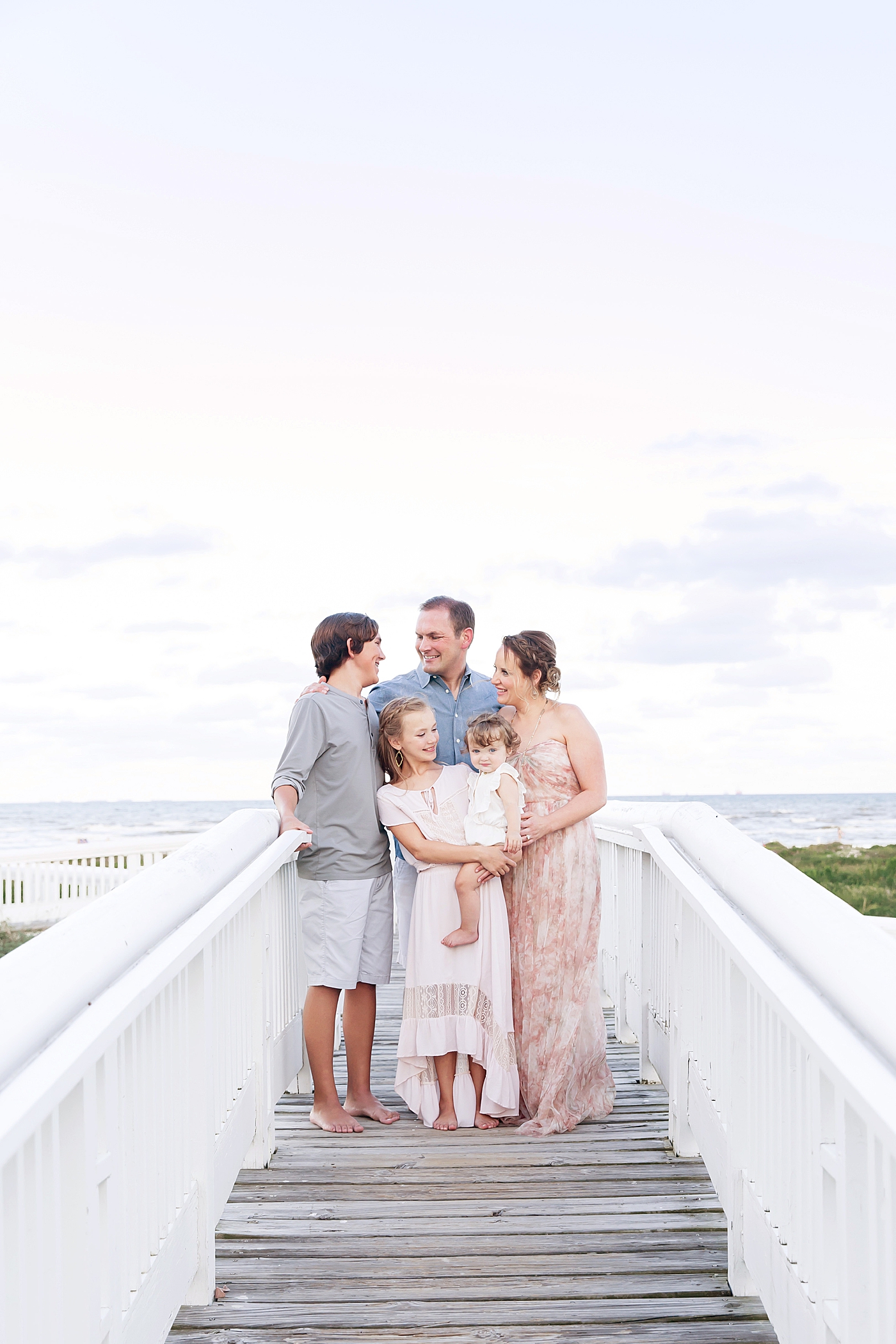 Family portrait with the beach in the background. Photo by Fresh Light Photography.