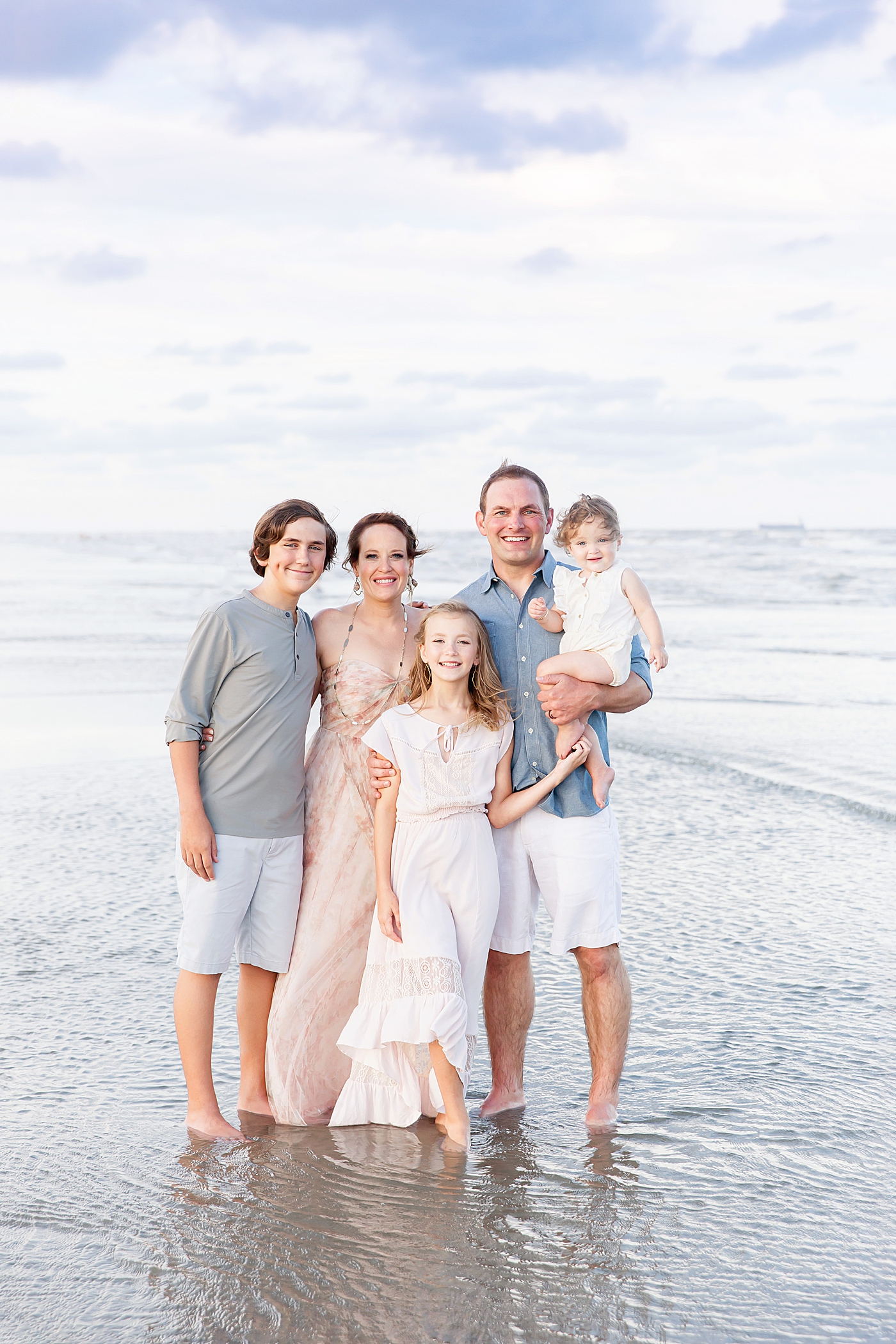 Family portrait along the water on Galveston Beach. Photo by Fresh Light Photography.