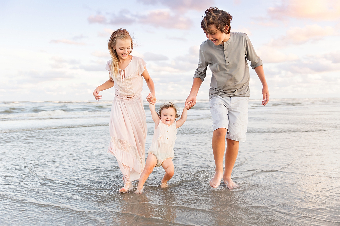 Sibling photos at sunset on Galveston Beach. Photo by Fresh Light Photography.