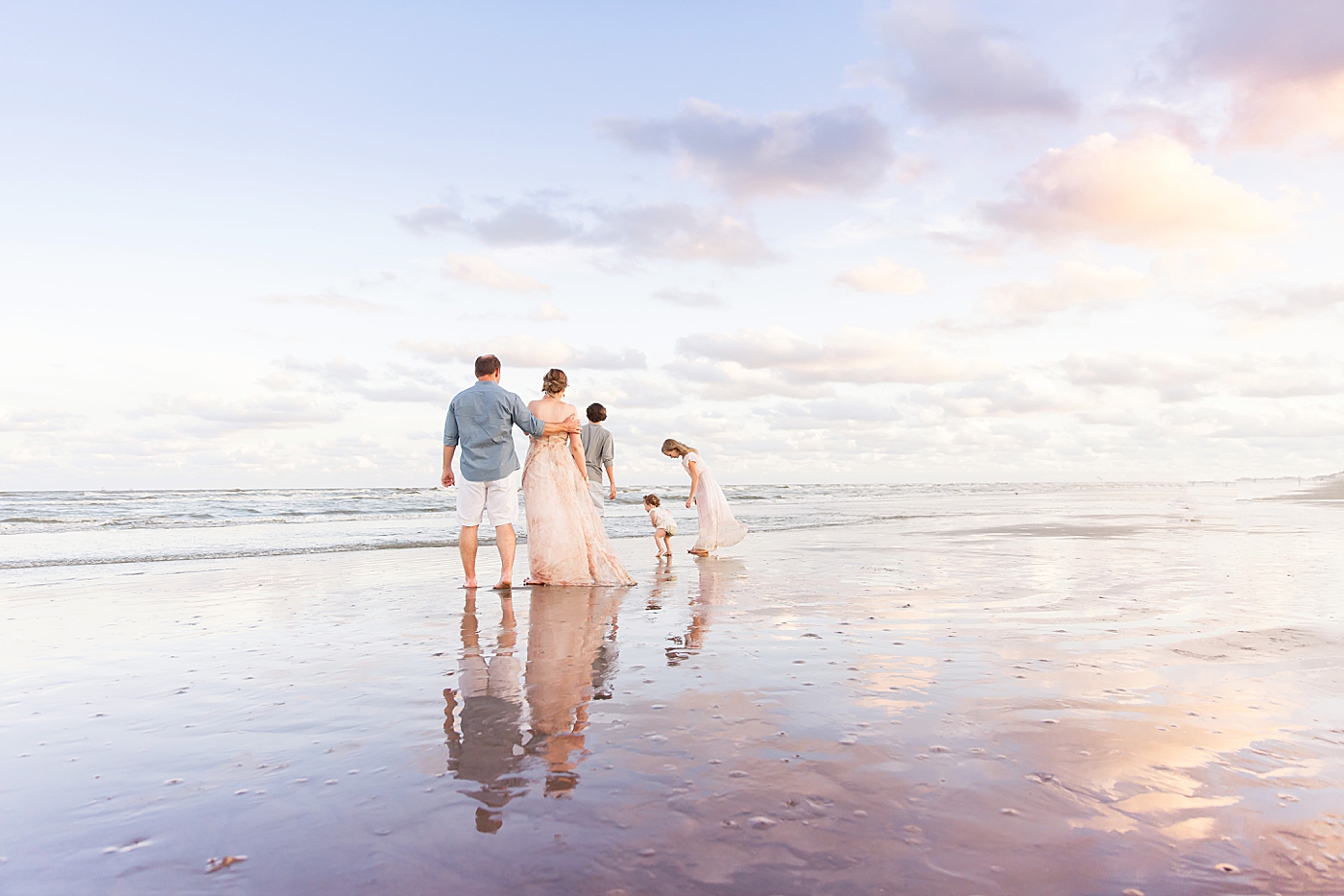 Family playing in the water at Galveston. Photo by Fresh Light Photography.