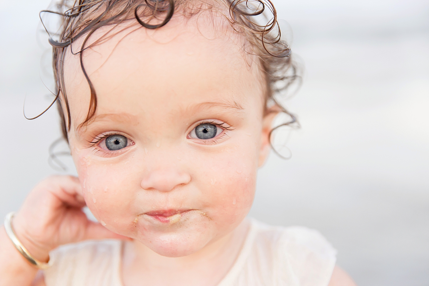 Toddler eating sand. Photo by Fresh Light Photography during family session on Galveston Beach.