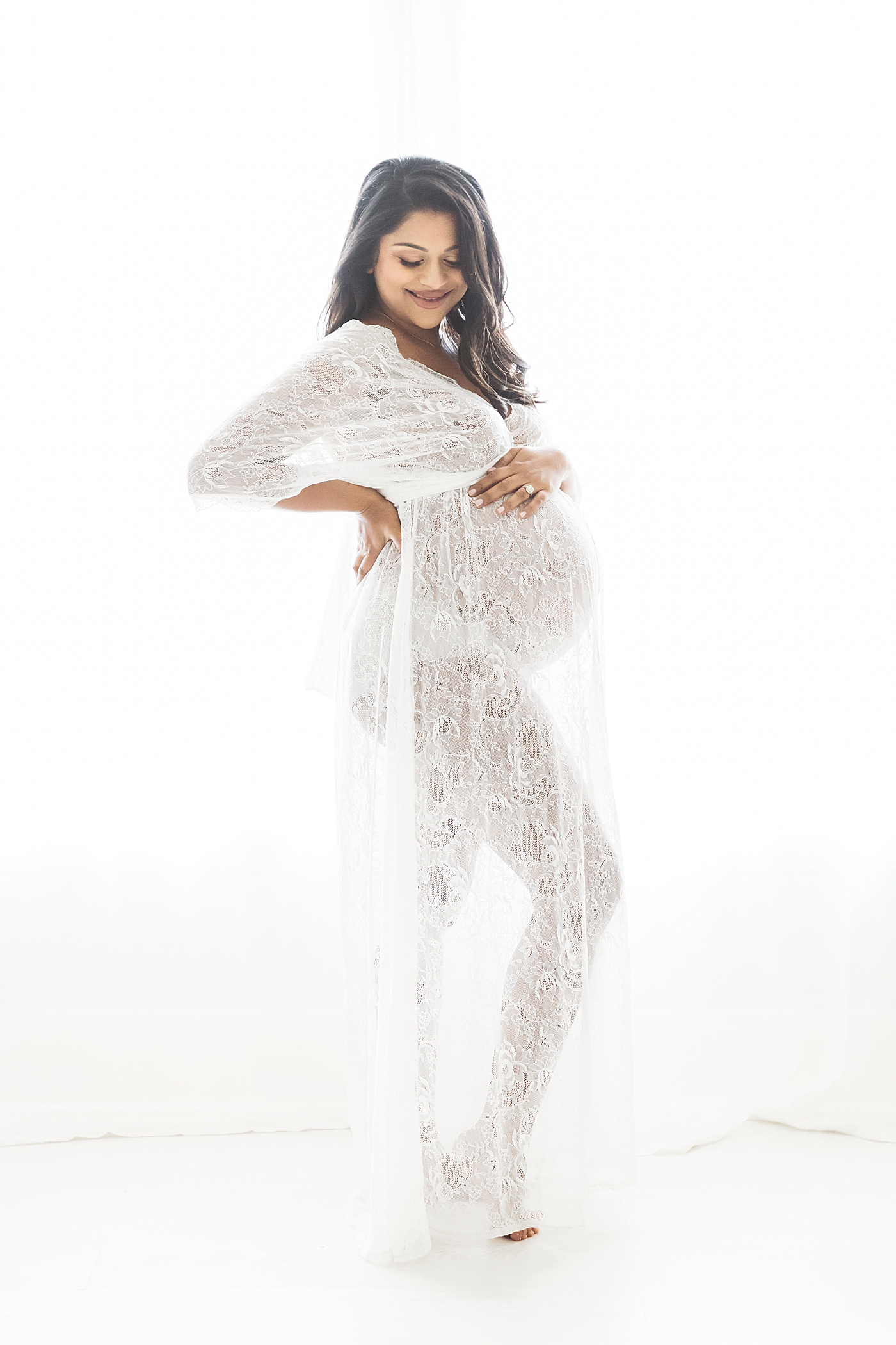 Pregnant mama in a beautiful, white lace dress. Photo by Fresh Light Photography.
