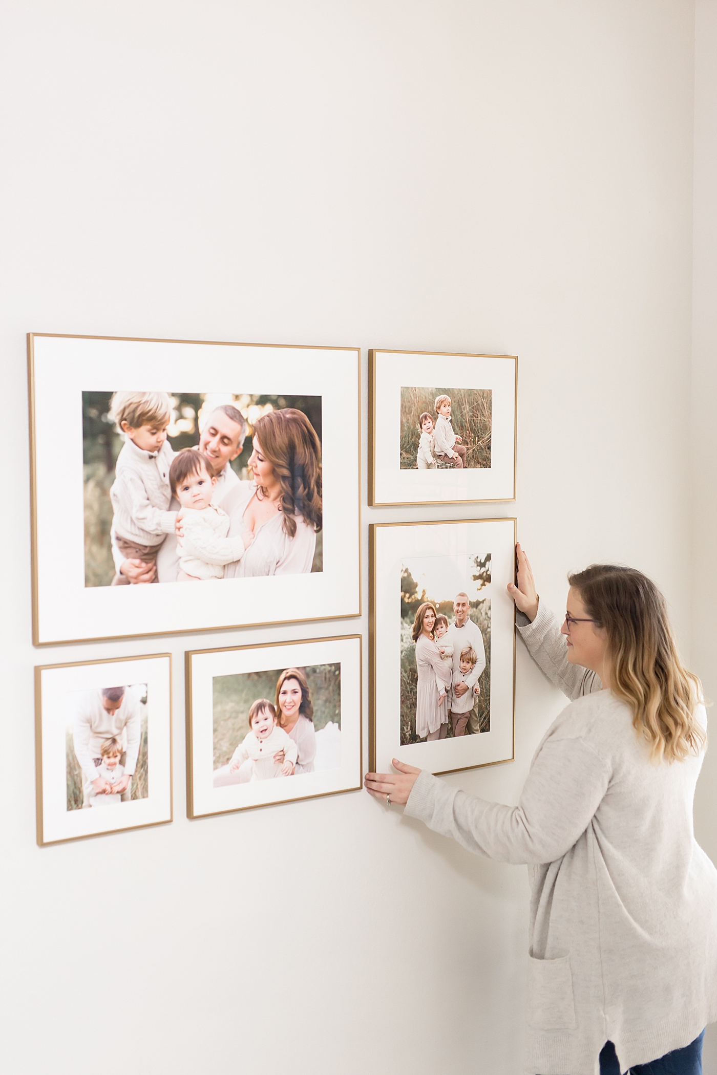 Leigh with Fresh Light Photography installs beautiful gallery wall in client's home in Houston.